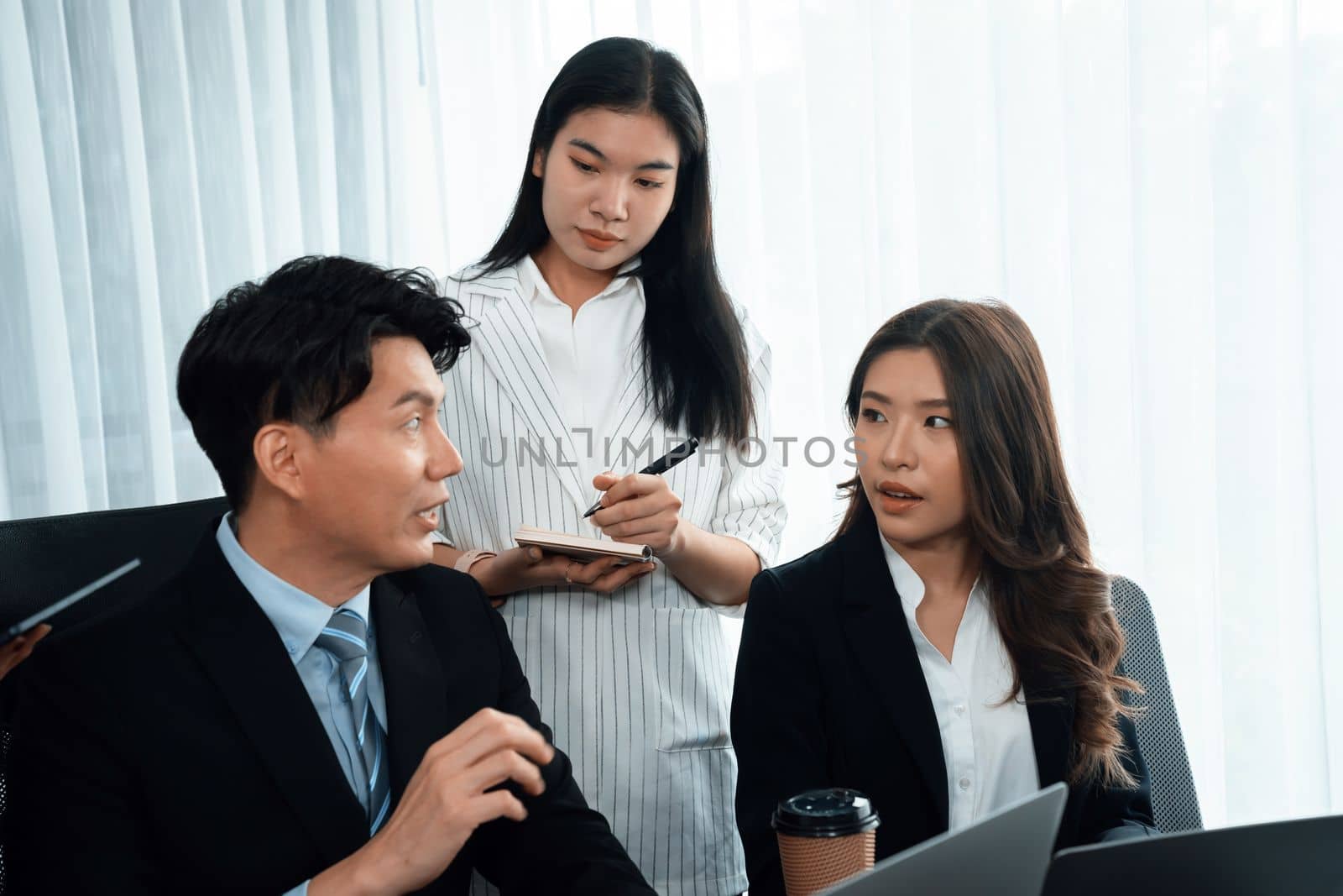 Harmony in office concept as business people analyzing dashboard paper together in workplace. Young colleagues give ideas at manager desk for discussion or strategy planning about project.