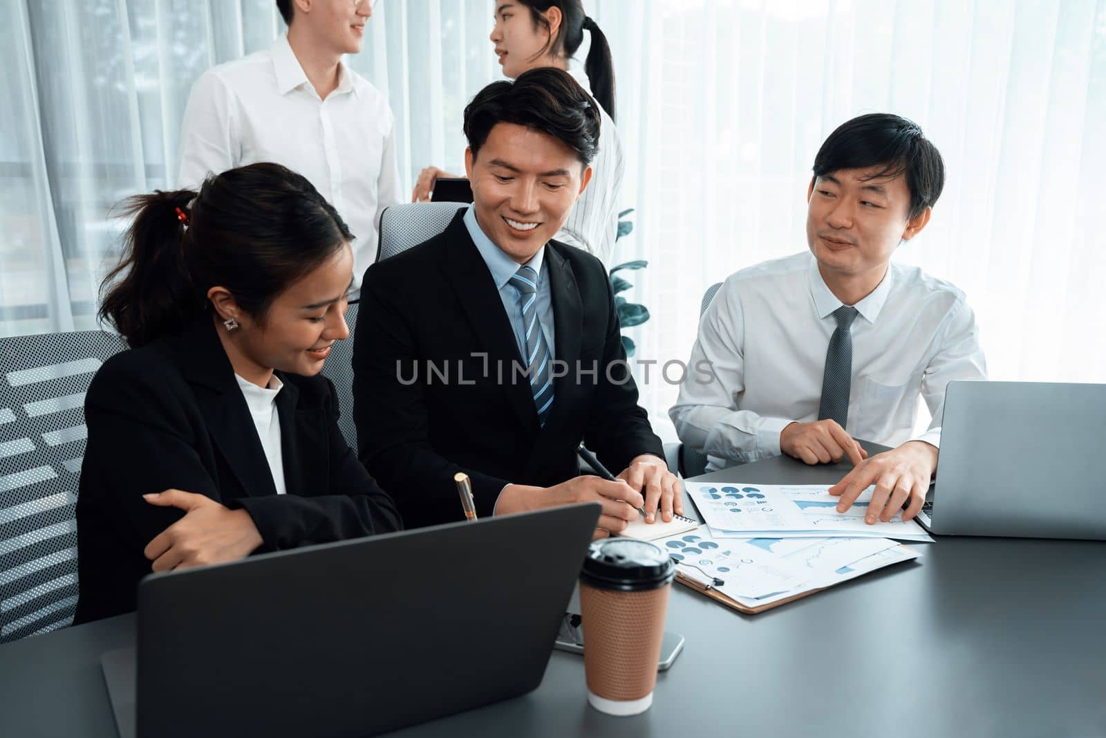 Office worker and manager analyze financial report paper in harmony workplace. by biancoblue