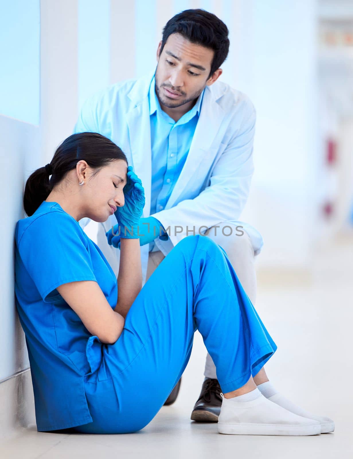Being a doctor is never easy. a young male dentist offering comfort to his assistant