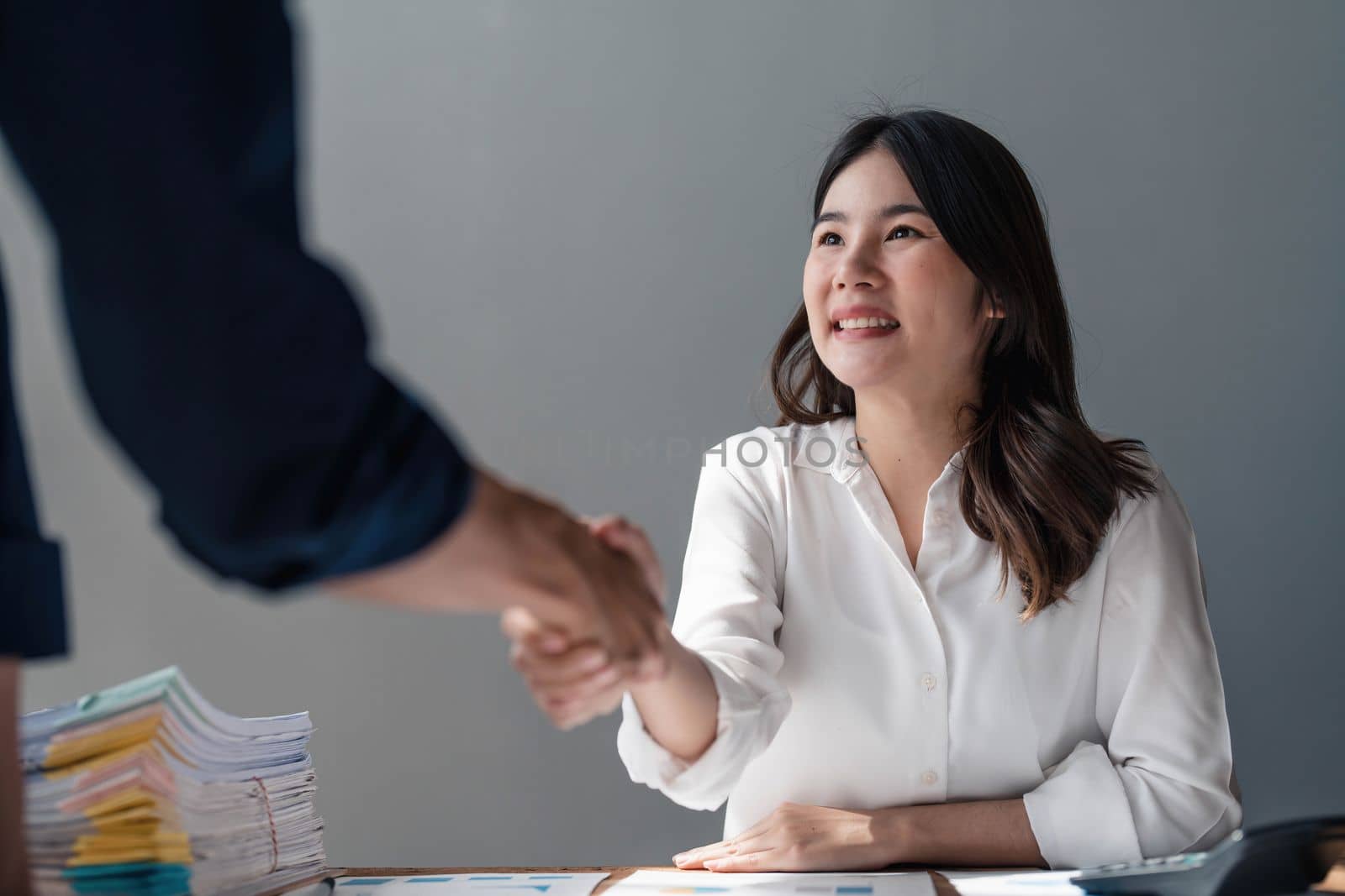 Business handshake for teamwork of business merger and acquisition,successful negotiate,hand shake,two businessman shake hand with partner to celebration partnership and business deal concept.. by wichayada