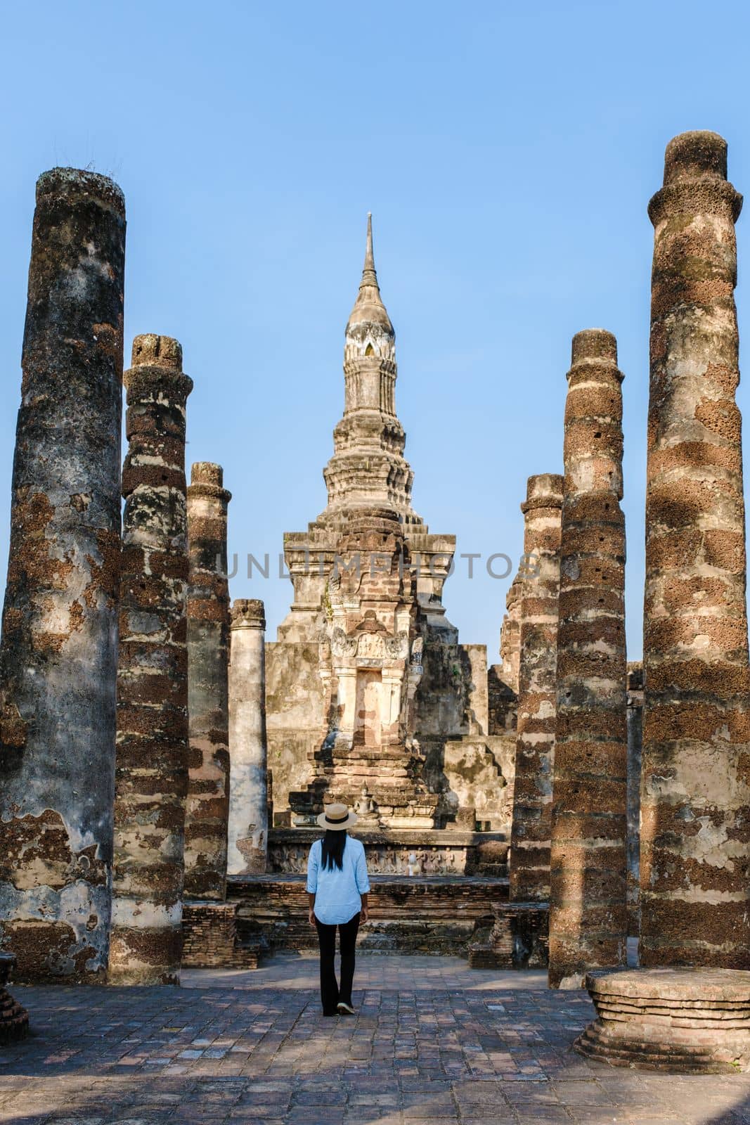 Women visit Wat Mahathat, Sukhothai old city, Thailand. Sukothai historical park by fokkebok