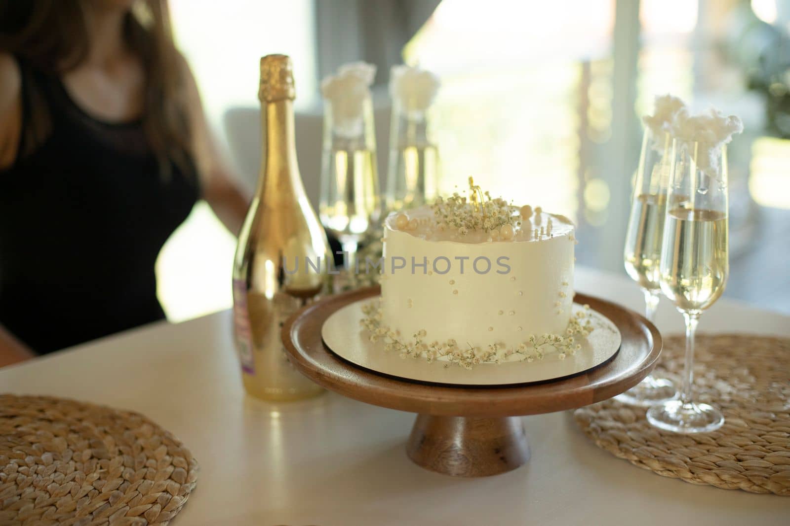 White cake. Sweet cake and glasses of champagne. Cake on table. Refreshments for guests. by OlegKopyov