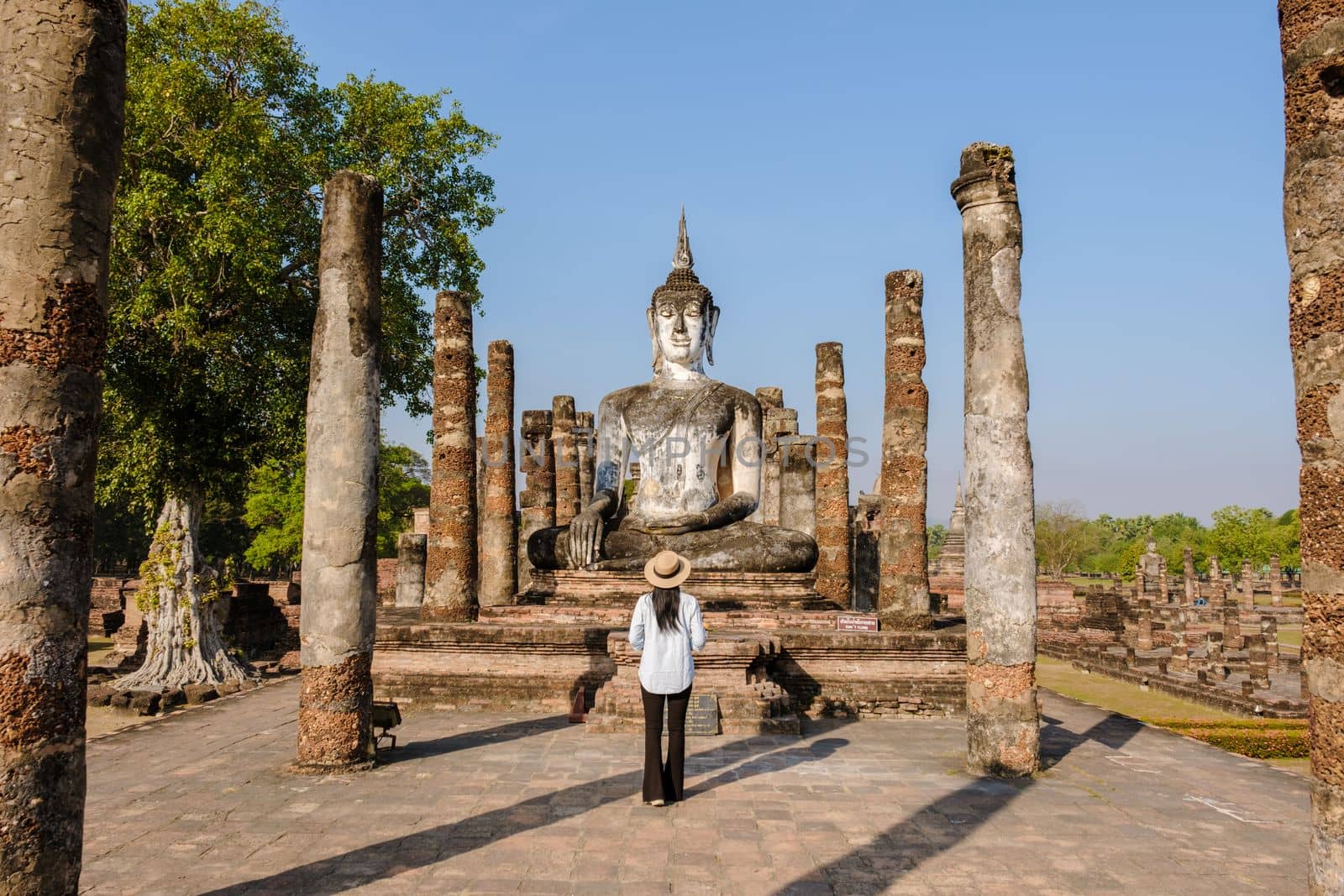 Women visit Wat Mahathat, Sukhothai old city, Thailand. Sukothai historical park by fokkebok