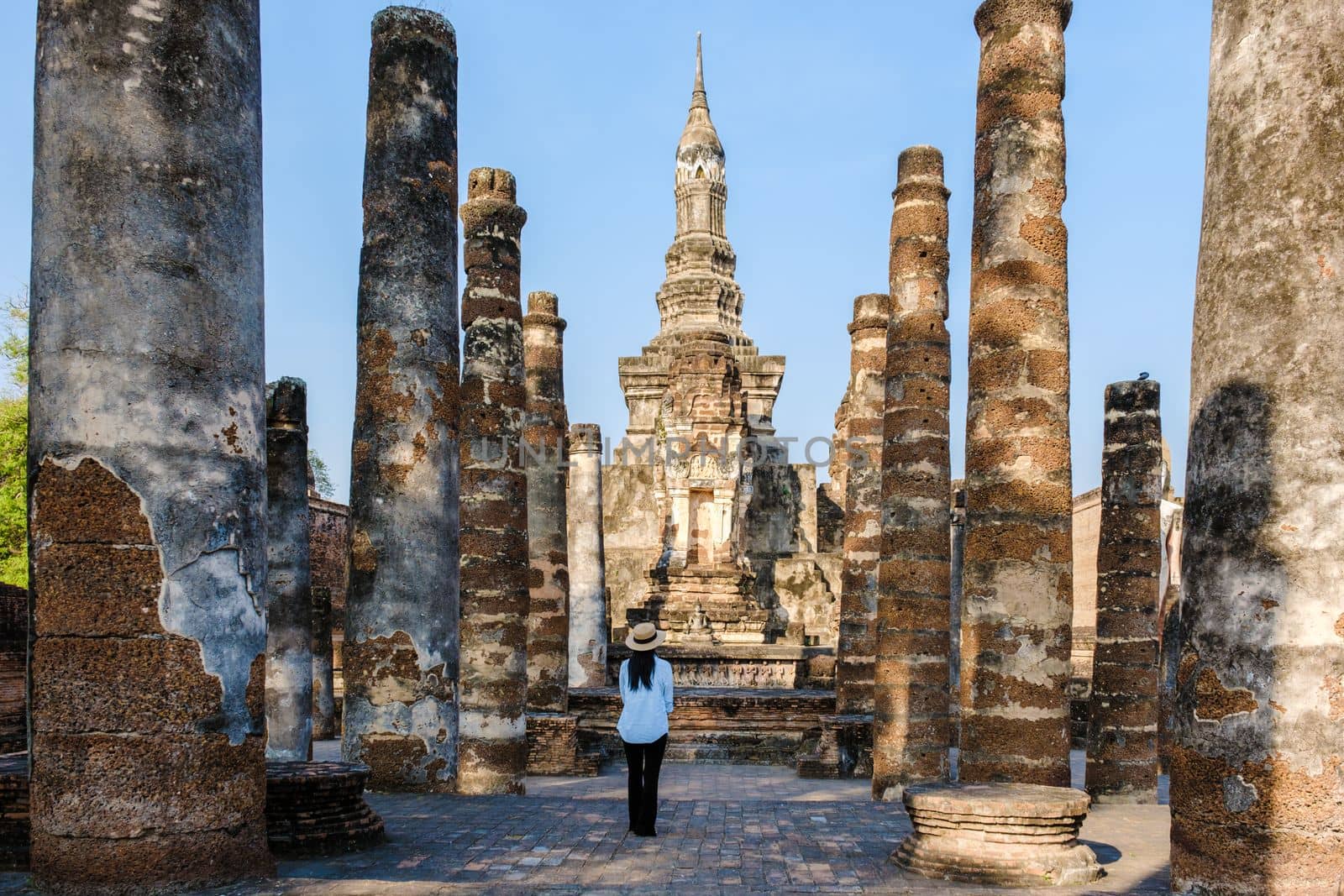 Women visit Wat Mahathat, Sukhothai old city, Thailand. Sukothai historical park by fokkebok