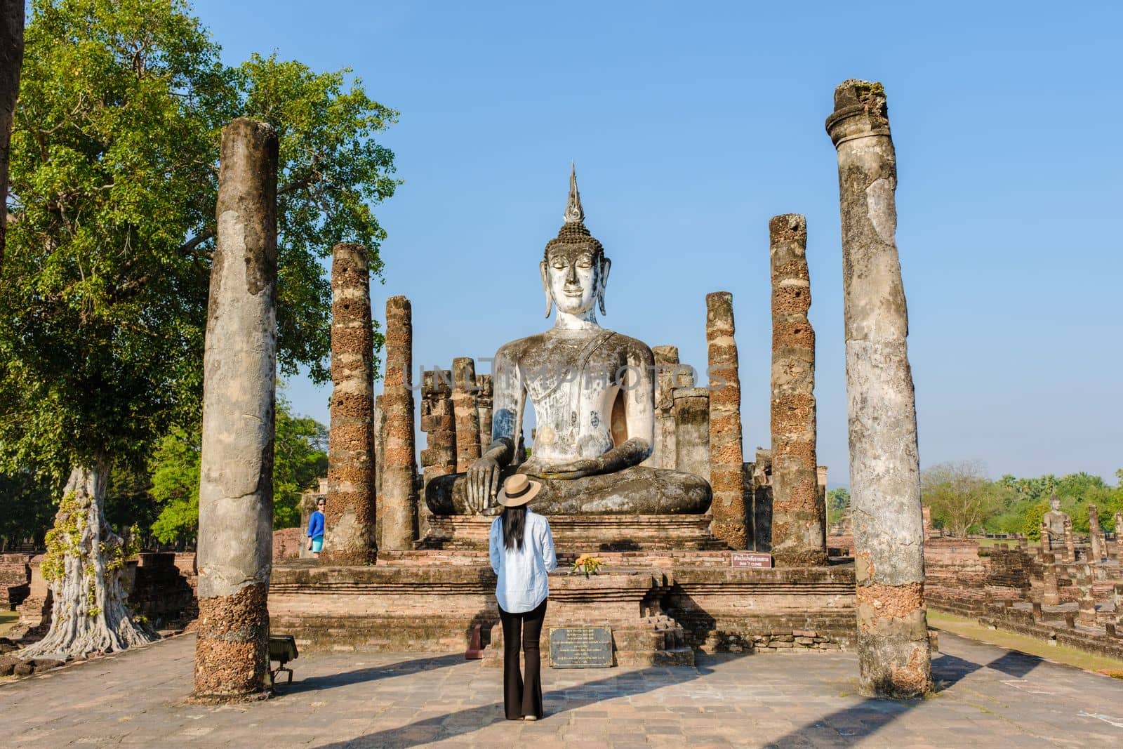 Women visit Wat Mahathat, Sukhothai old city, Thailand. Sukothai historical park by fokkebok
