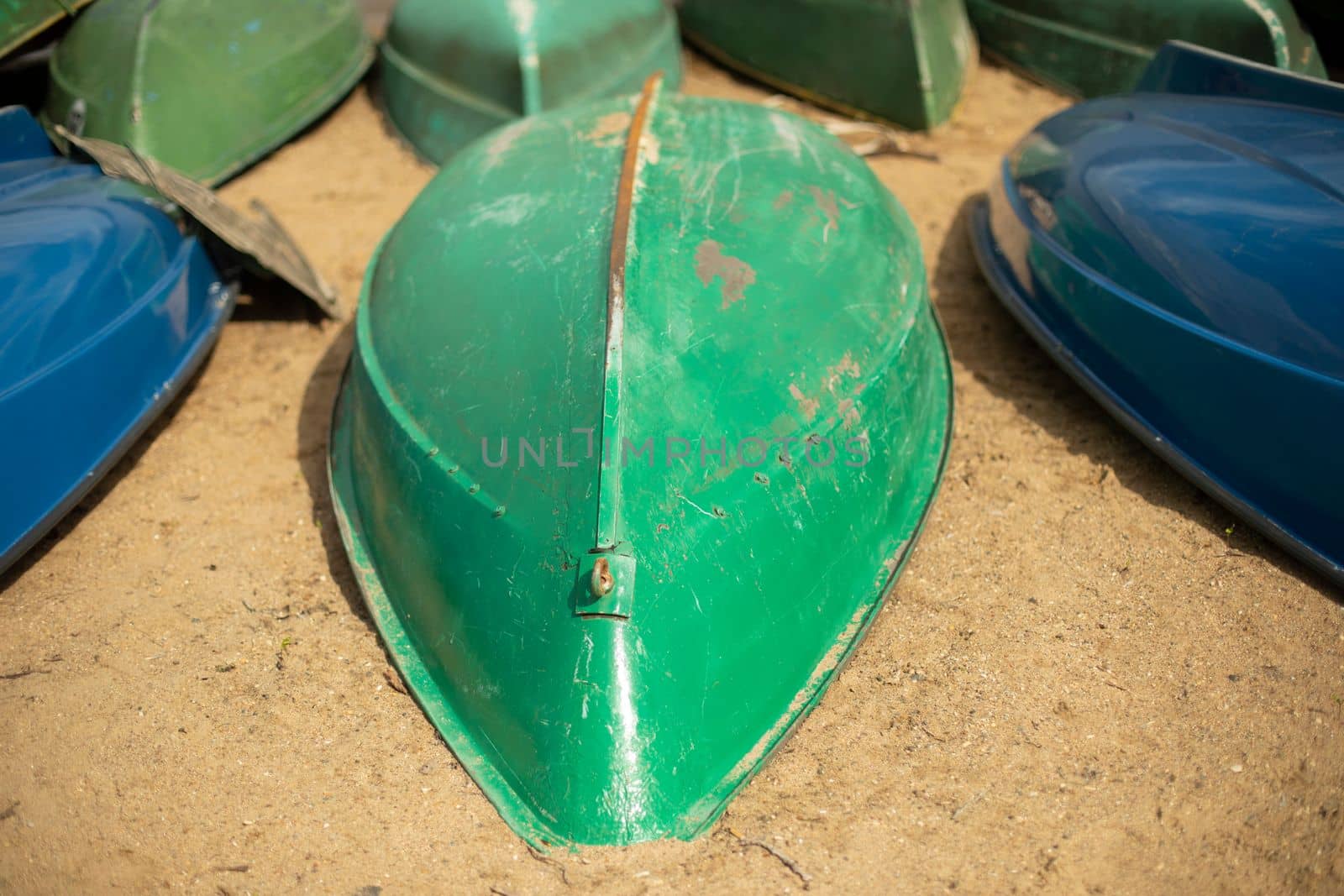 Green boat on sand. Boat station. Beach by sea.