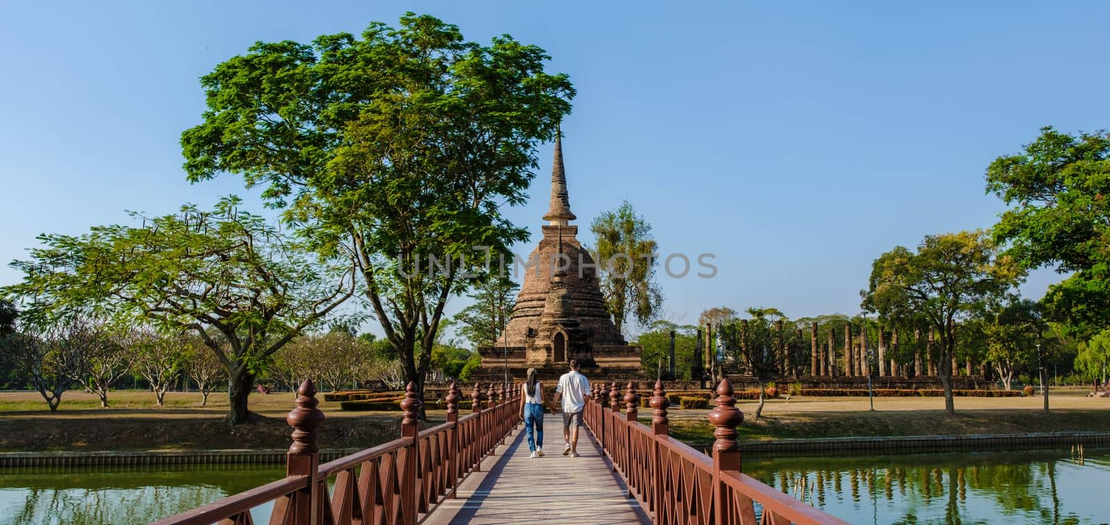A couple of men and women visiting Wat Sa Si, Sukhothai old city, Thailand., Sukothai historical park by fokkebok
