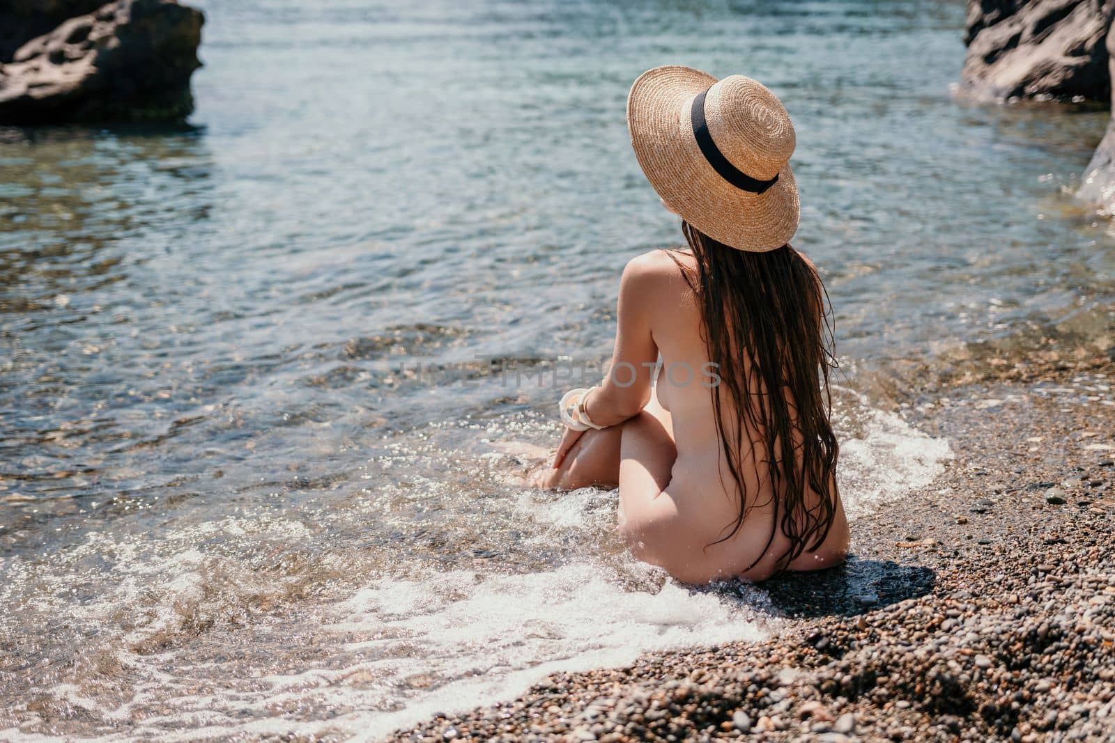 Woman travel sea. Happy tourist in hat enjoy taking picture outdoors for memories. Woman traveler posing on the beach at sea surrounded by volcanic mountains, sharing travel adventure journey by panophotograph