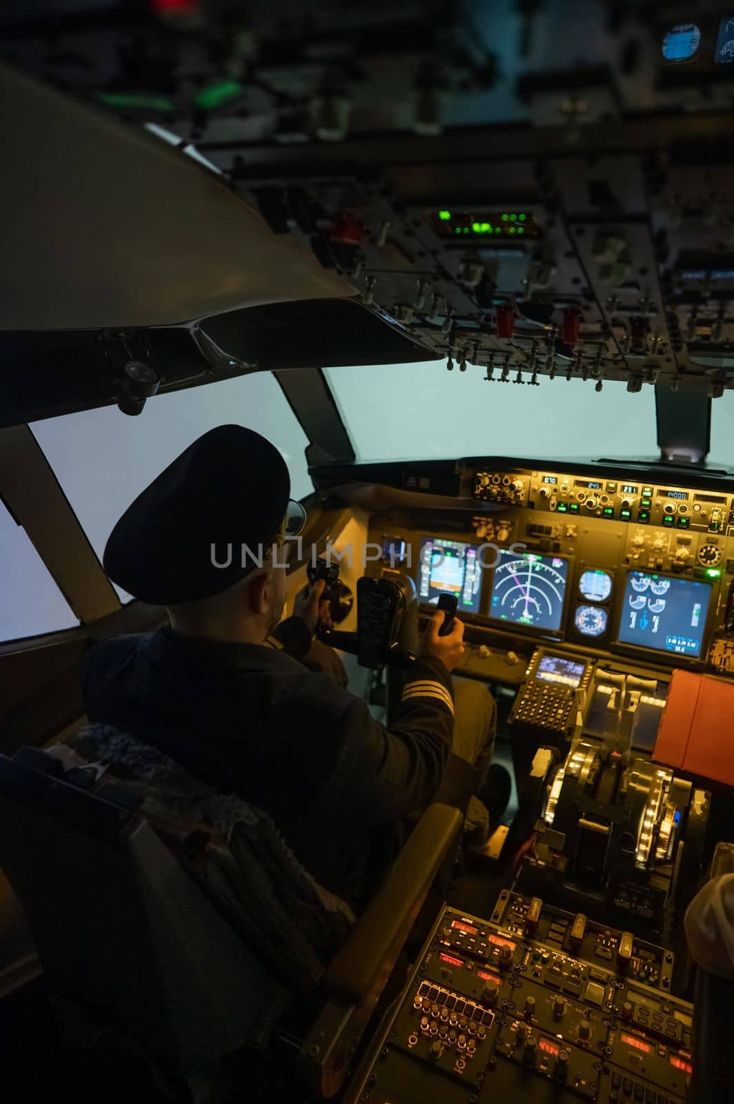 A man is studying to be a pilot in an aircraft simulator