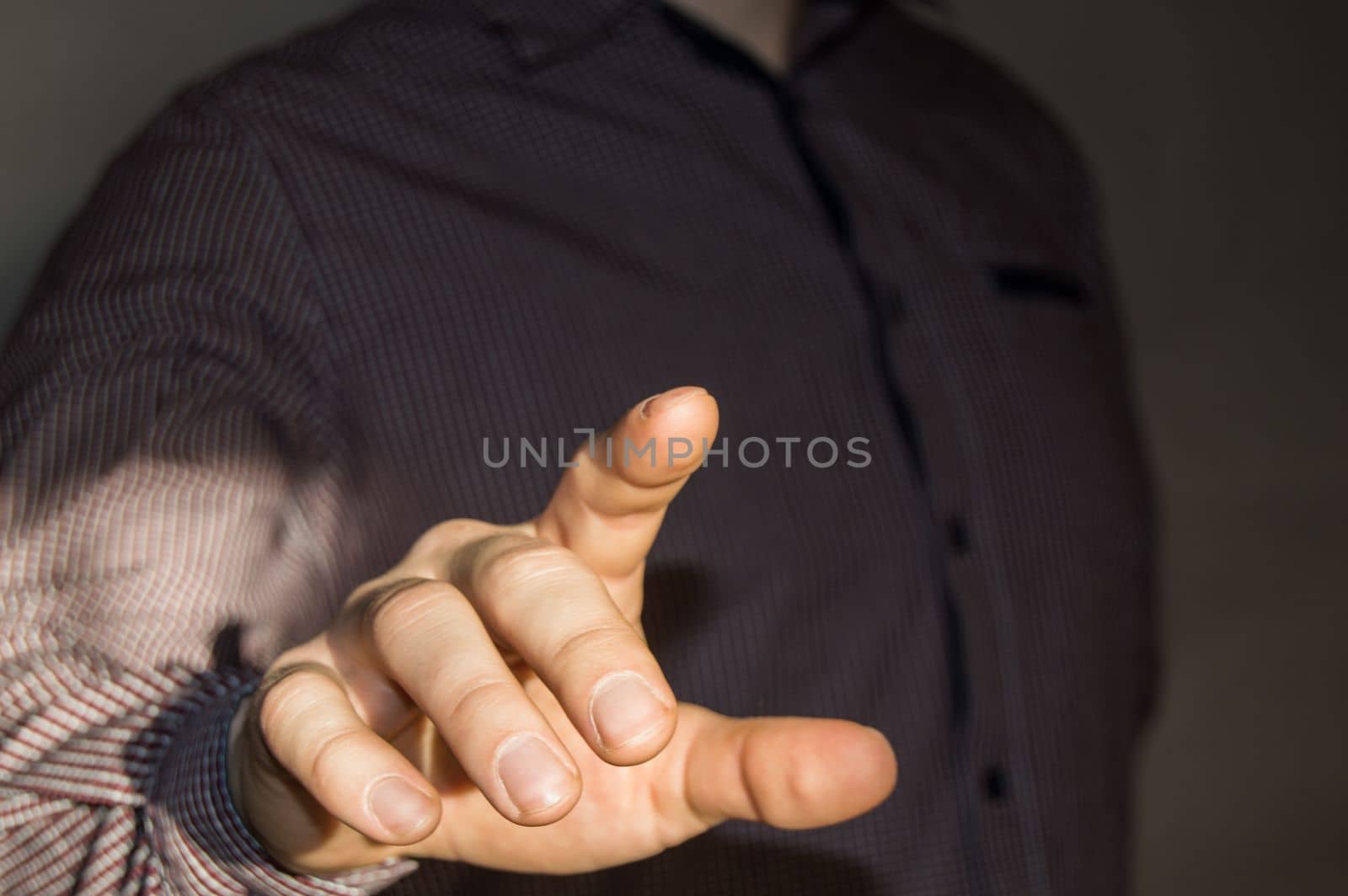 Businessman pointing finger at blank virtual screen by pressing virtual button