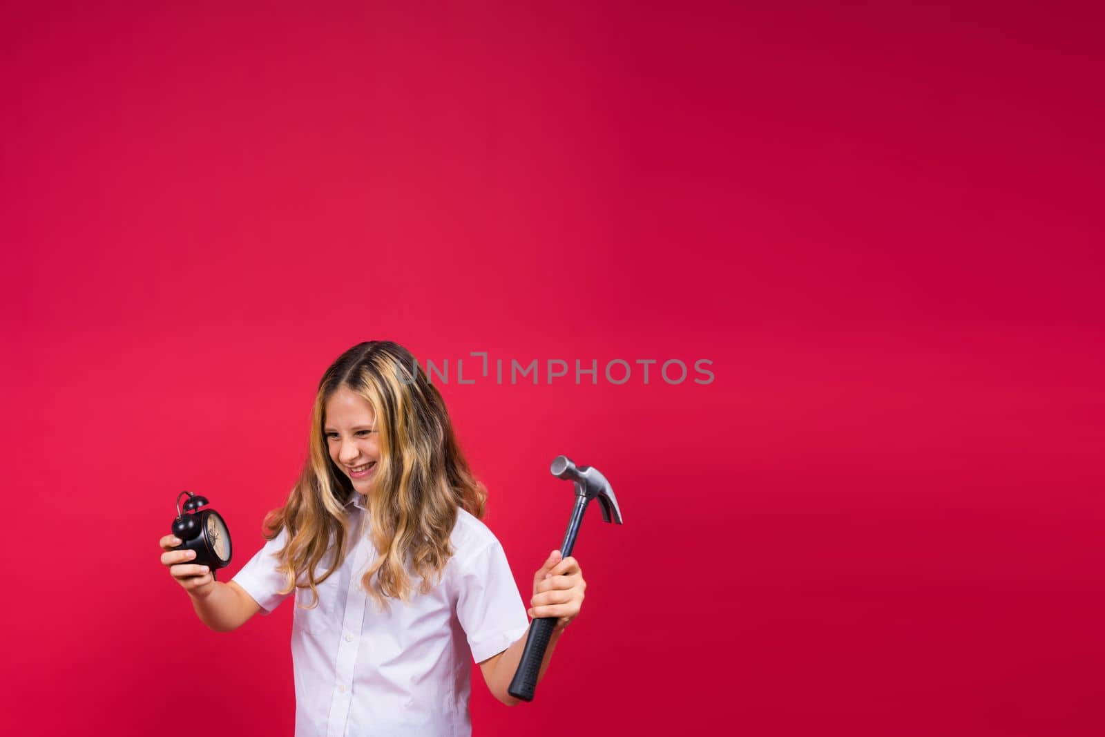 Kid girl holding hammer and alarm clock smiling with a happy and cool smile on face. showing teeth. by Zelenin