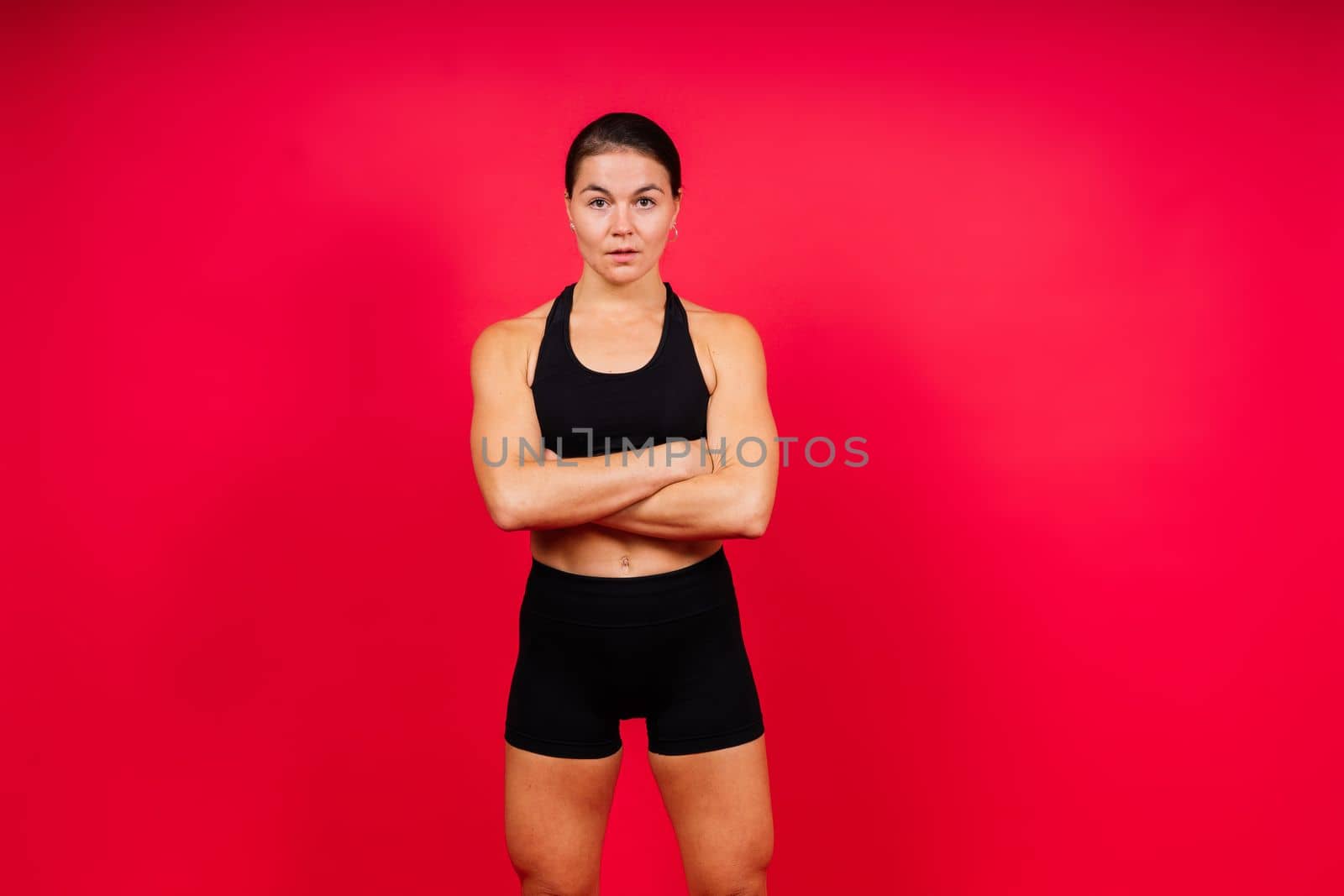 Cool female fighter in boxing bandages trains in studio. Mixed martial arts. by Zelenin