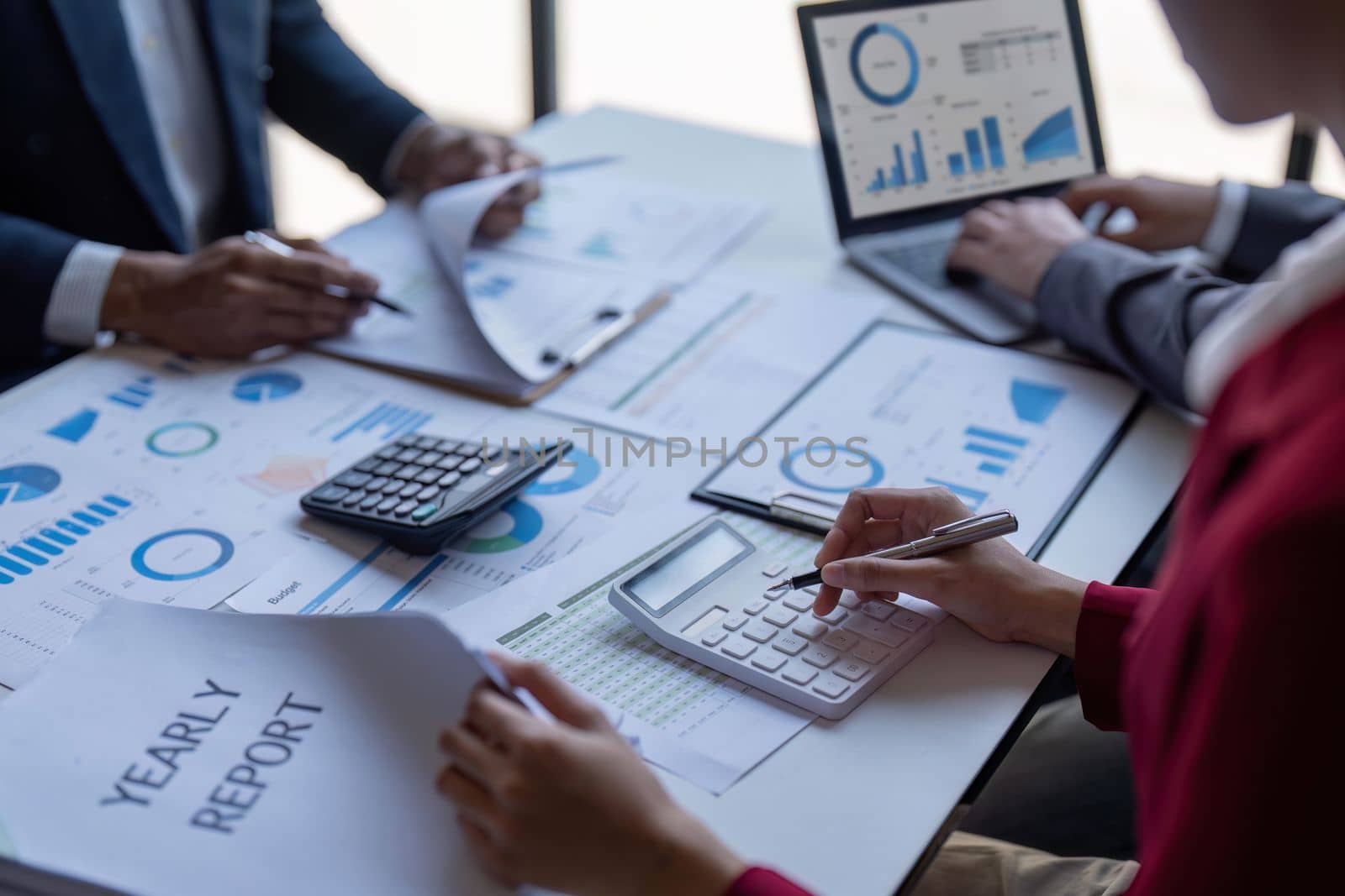 Team of business investment consultant analyzing company annual financial report working with documents pie and donut chart, using laptop, Business and Financial concept.