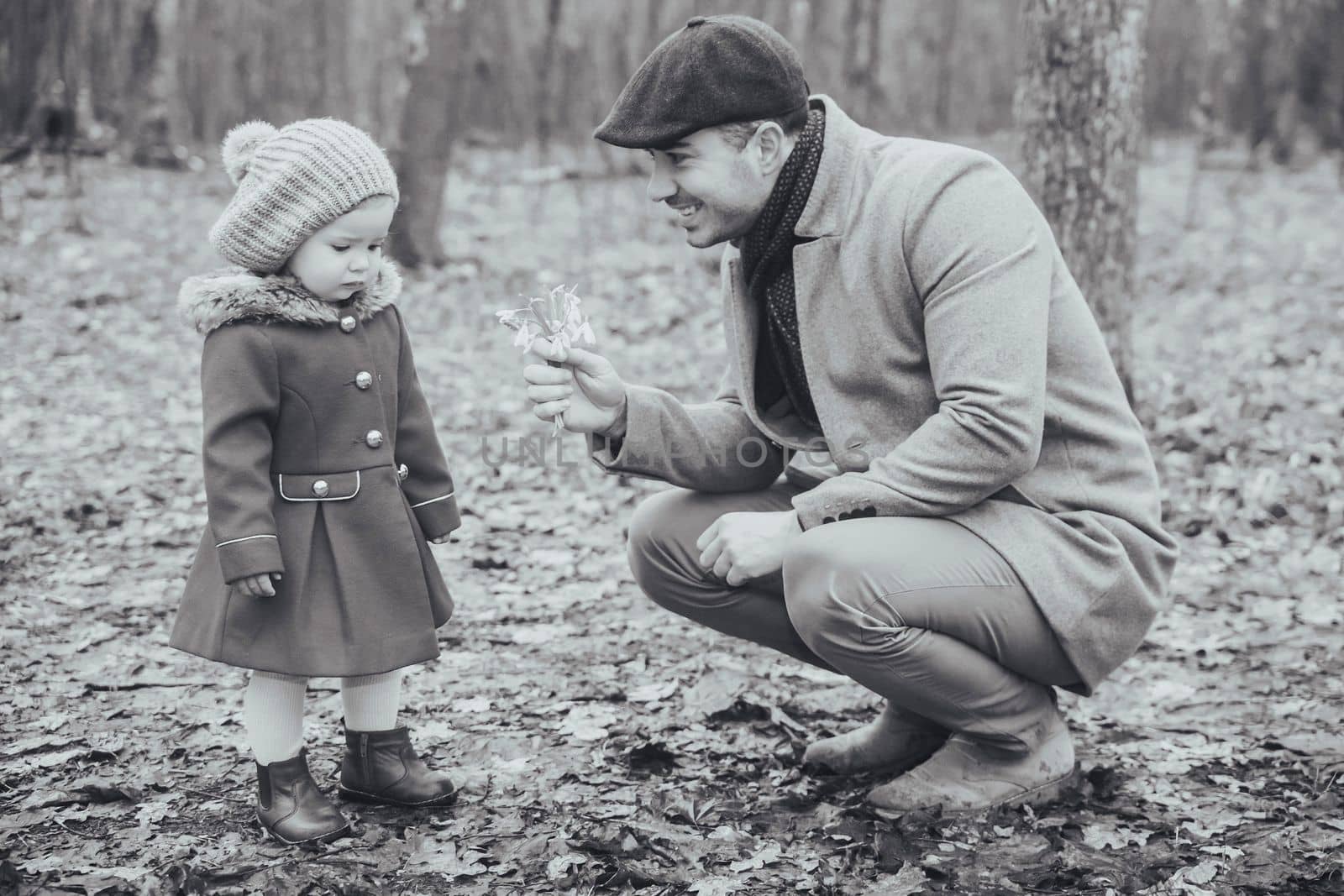 Retro photo of a father giving flowers to a sad daughter by Viktor_Osypenko