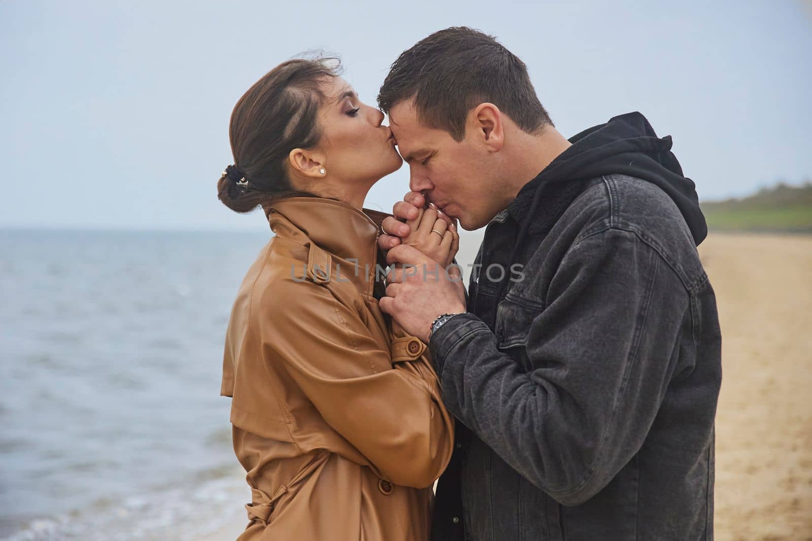 Ribe, Denmark, October, 2022: Newlyweds kissing on the beach.