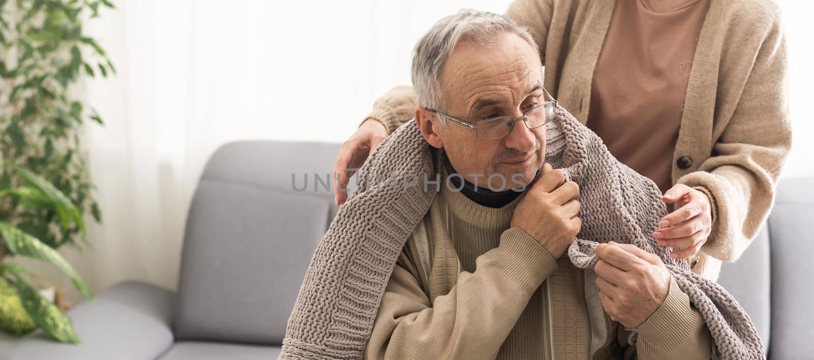 Senior couple, happy and laughing in their home with love, care and support for retirement lifestyle. Commitment of a funny man and woman in a marriage with trust and security on a living room couch