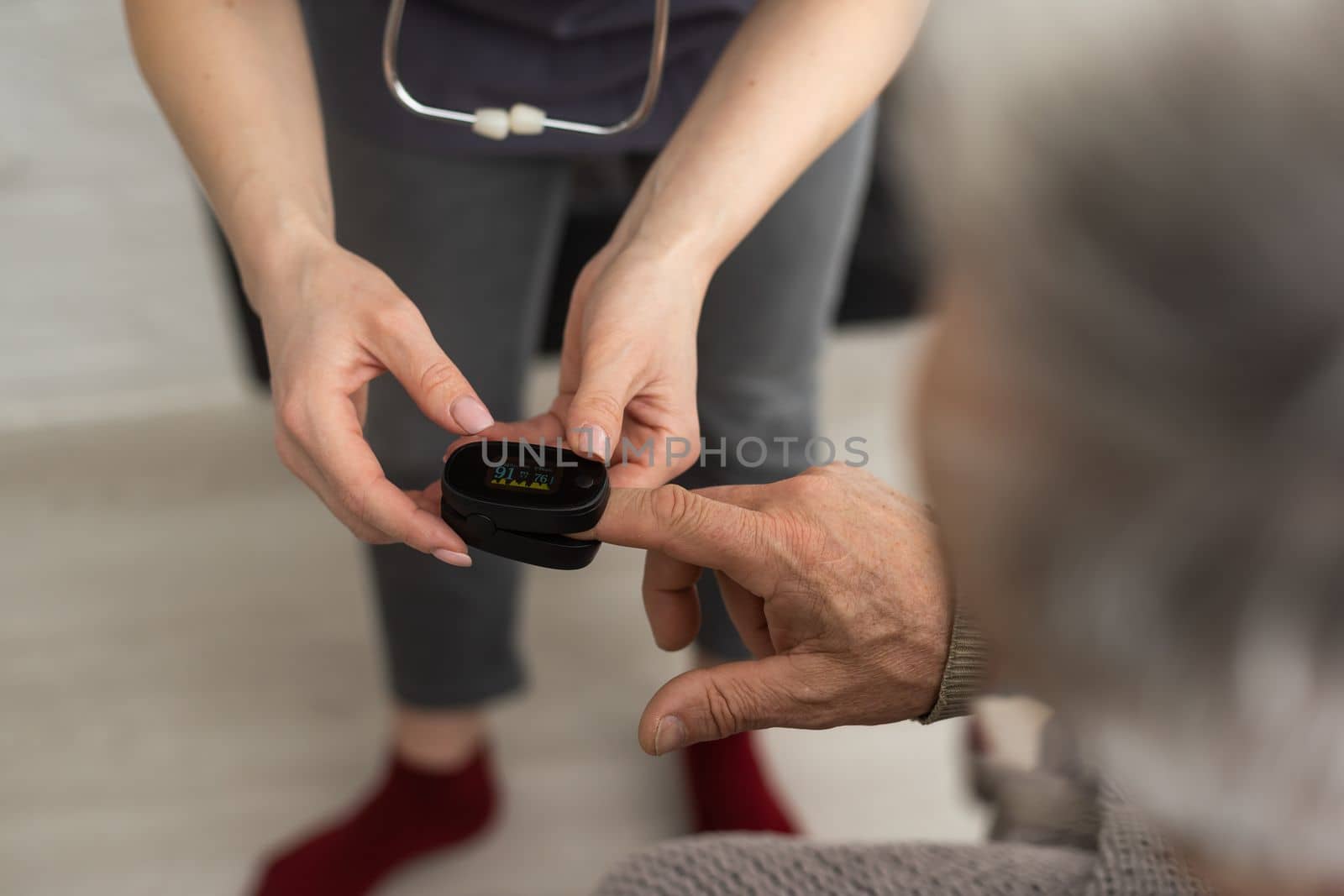 Nurse use pulse oximeter to check patient's oxygen in home, Home healthcare service concept