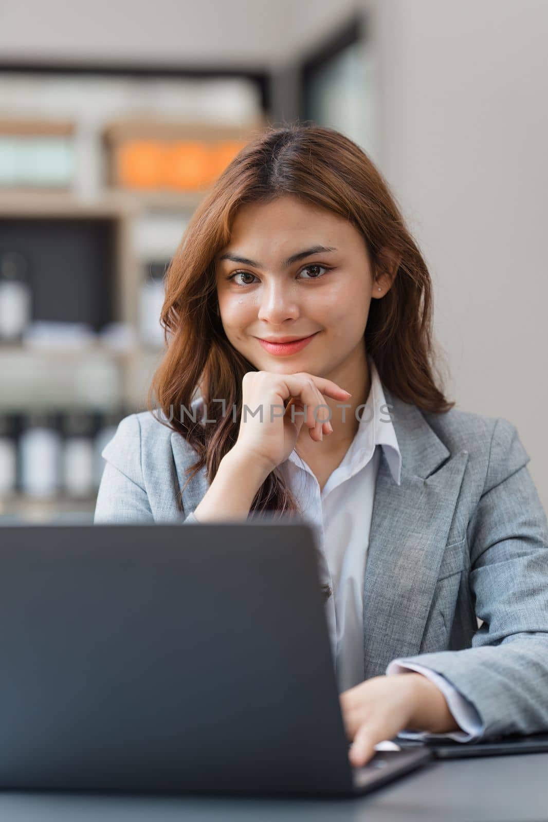 Female employee with coffee at workplace. Businesswoman preparing economic report
