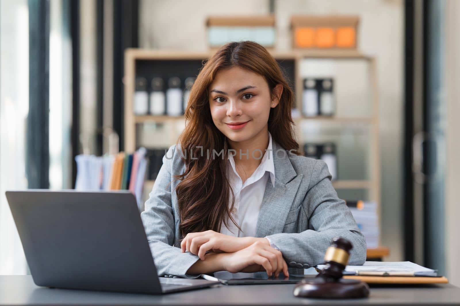 Business Lawyer consulting online on laptop while working at office