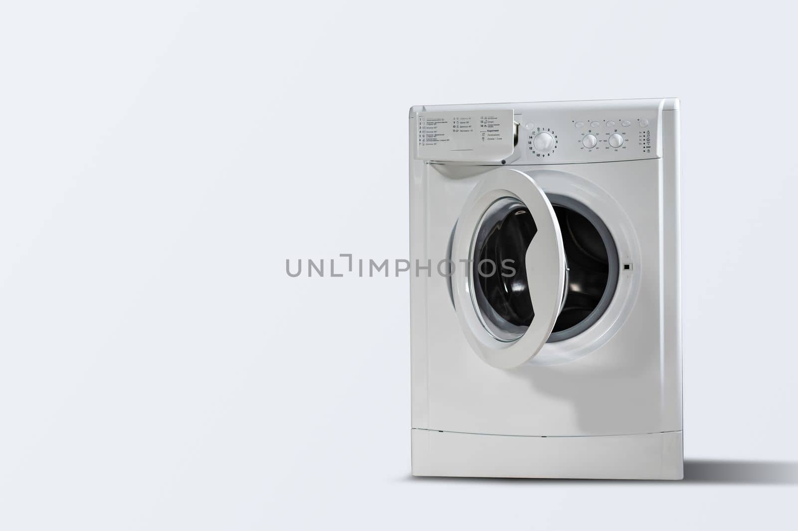 Modern washing machine white wall indoors, space for text. by Andelov13