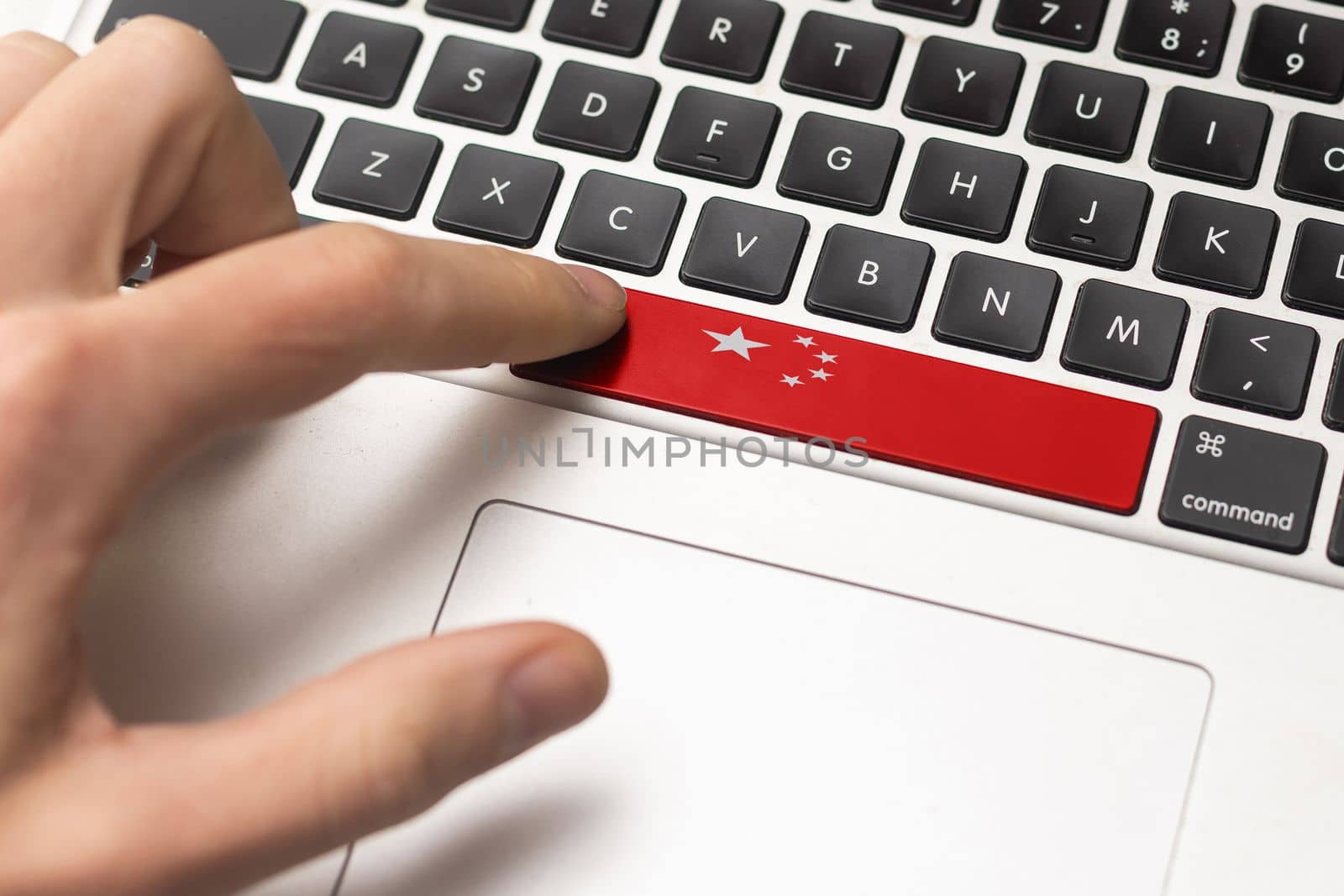 Online International Business concept: Computer key with the China flag on it. Male hand pressing computer key with China flag by Andelov13