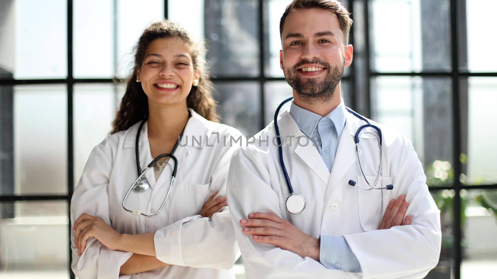 female doctor and male doctor stand in the lobby of the hospital