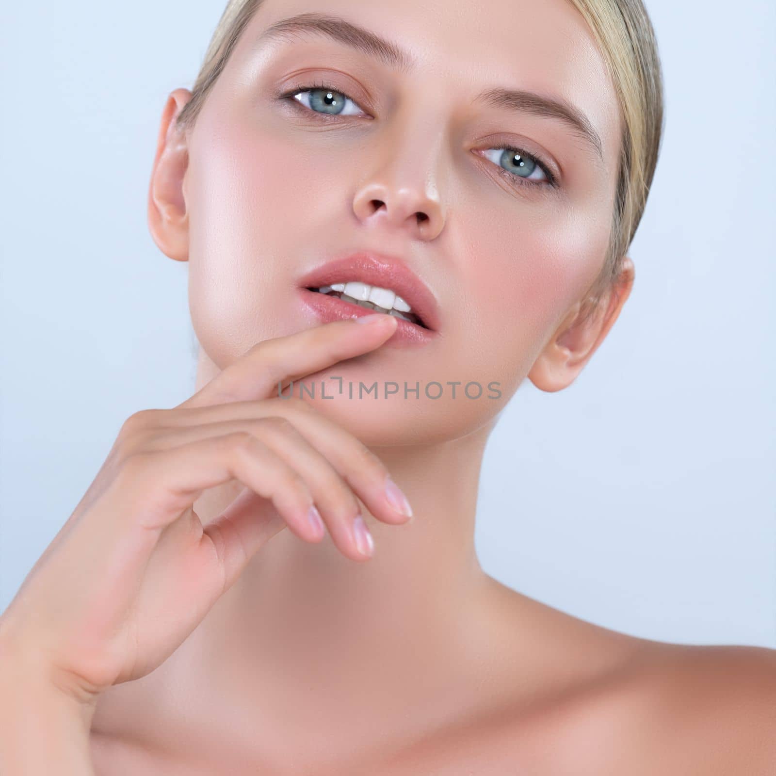 Closeup alluring beautiful woman with perfect smooth and clean skin portrait in isolated background. Beauty hand gesture with expressive facial expression for skincare treatment product or spa.