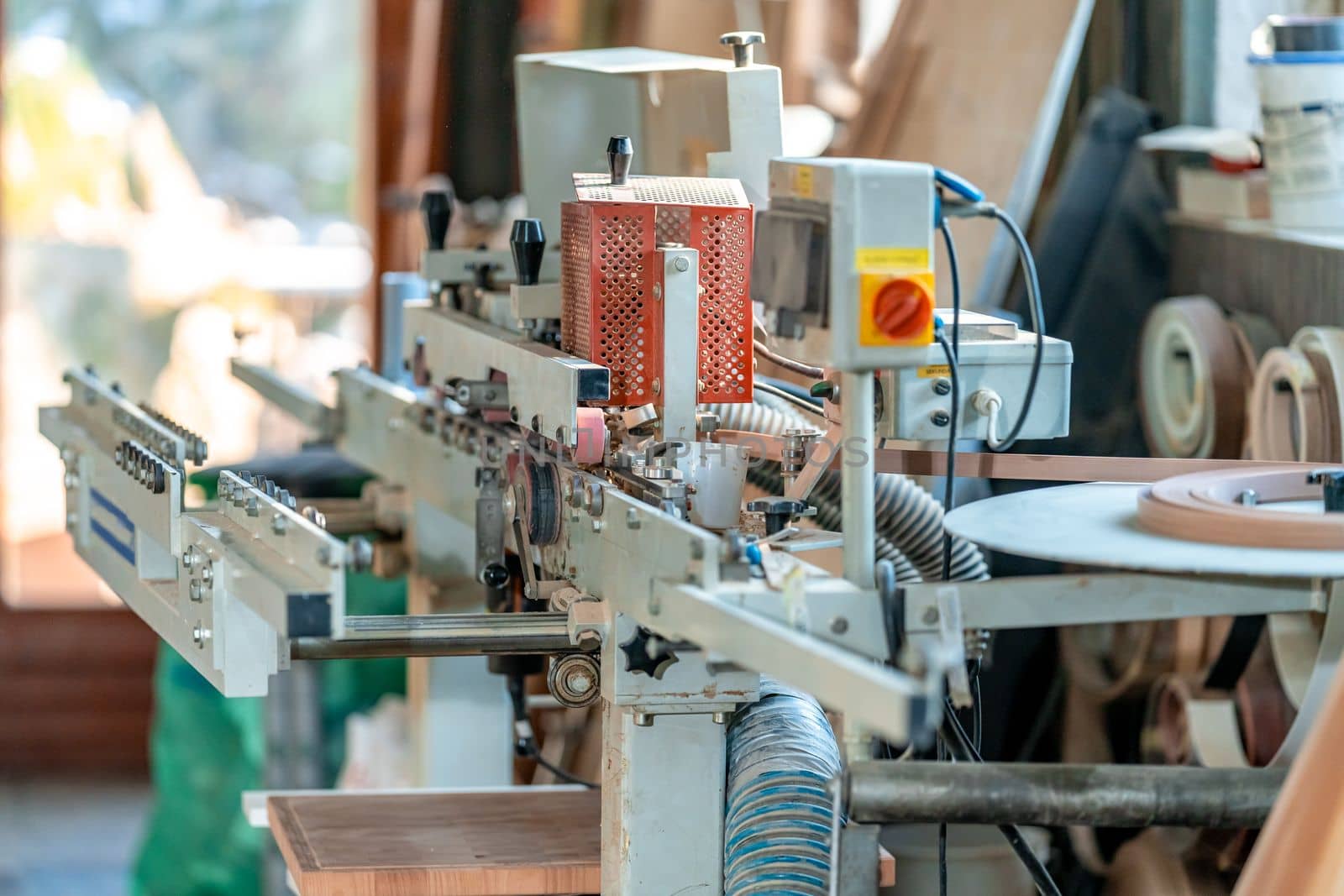 gluing the edge on a machine to a laminate board for the production of furniture in carpentry. High quality photo