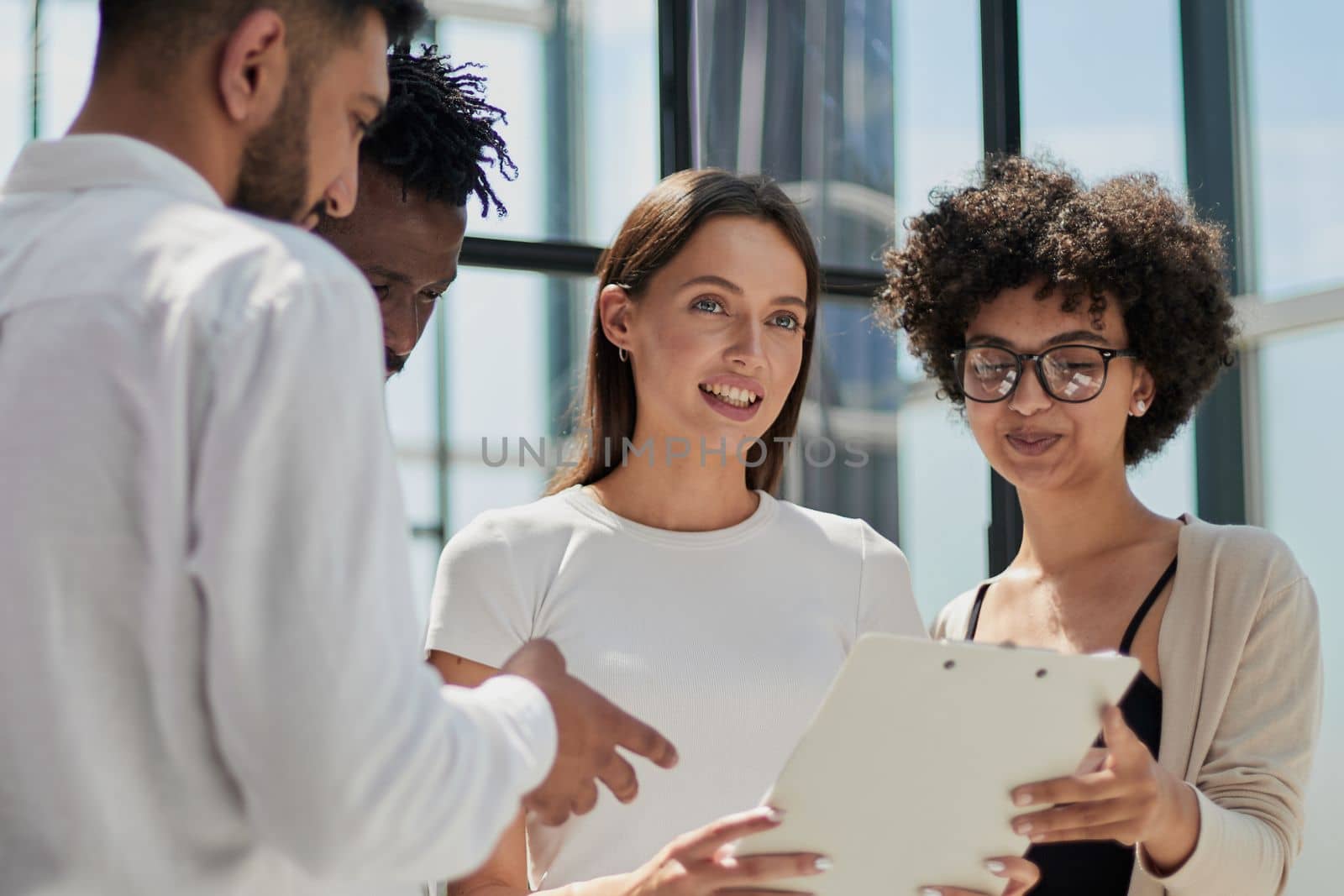 Employees working at computer together, discussing content by Prosto