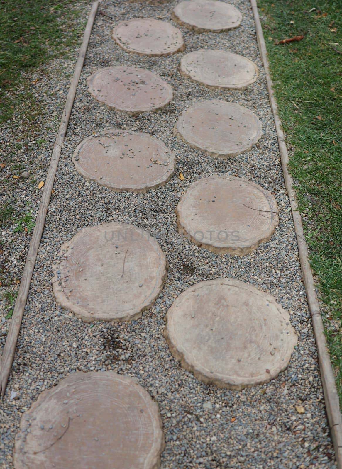 Simple pathway in home garden landscape. Path of plated stones on gravel bed. Garden architecture, pathway accessory to garden pond. by Proxima13