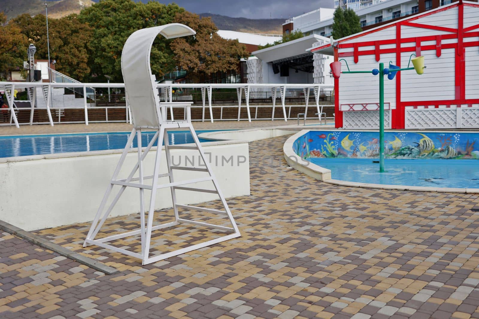 Observation tower next to the children's pools on site. The concept of children's safety on the water.