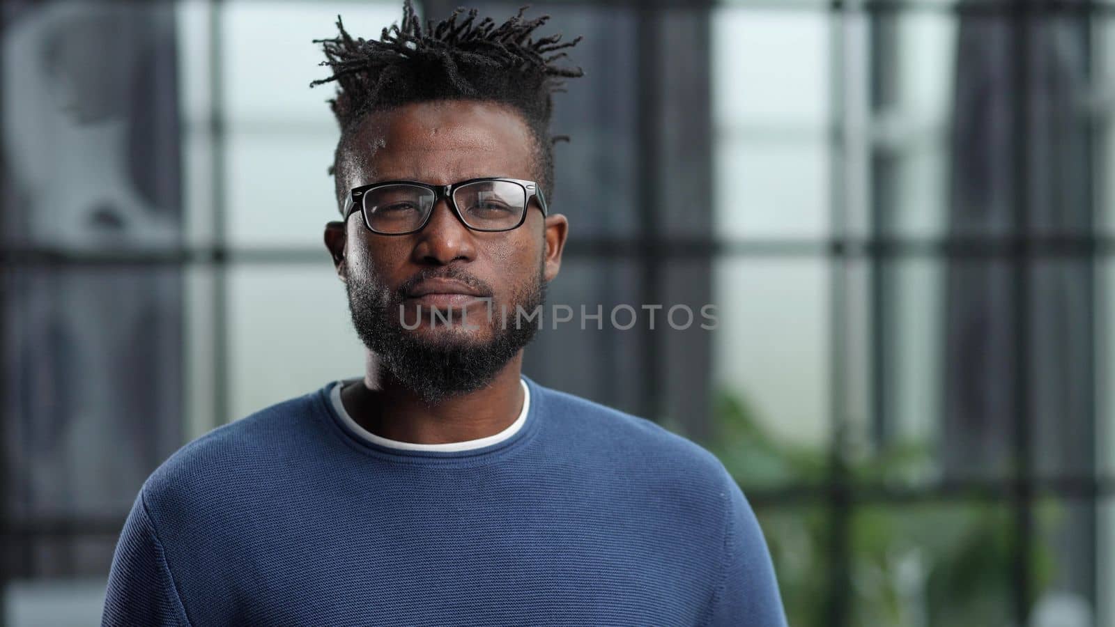 Portrait of a young businessman with a cup of coffee, in casual clothes
