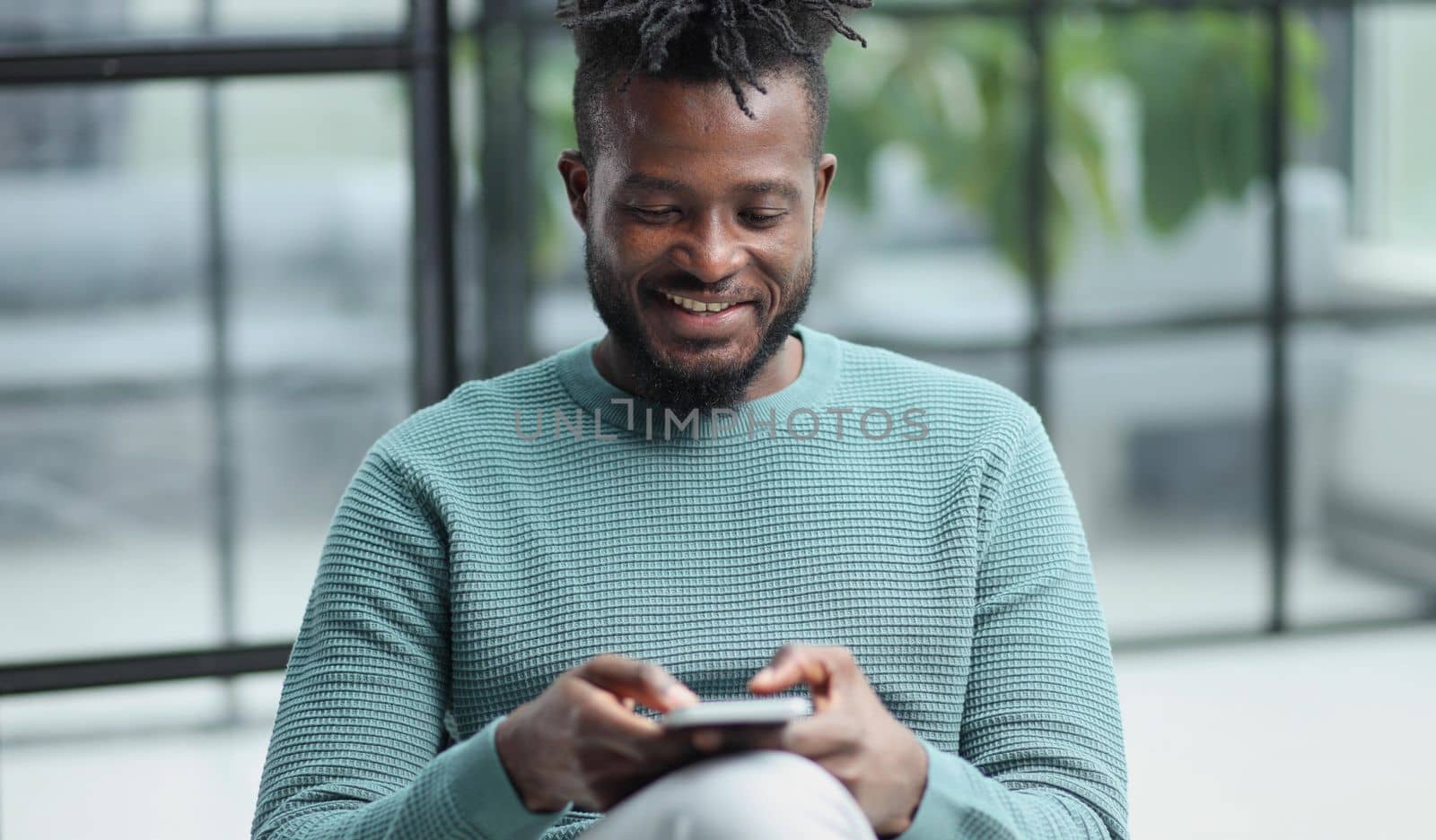 african american businessman using phone mobile corporate apps at workplace texting sms.
