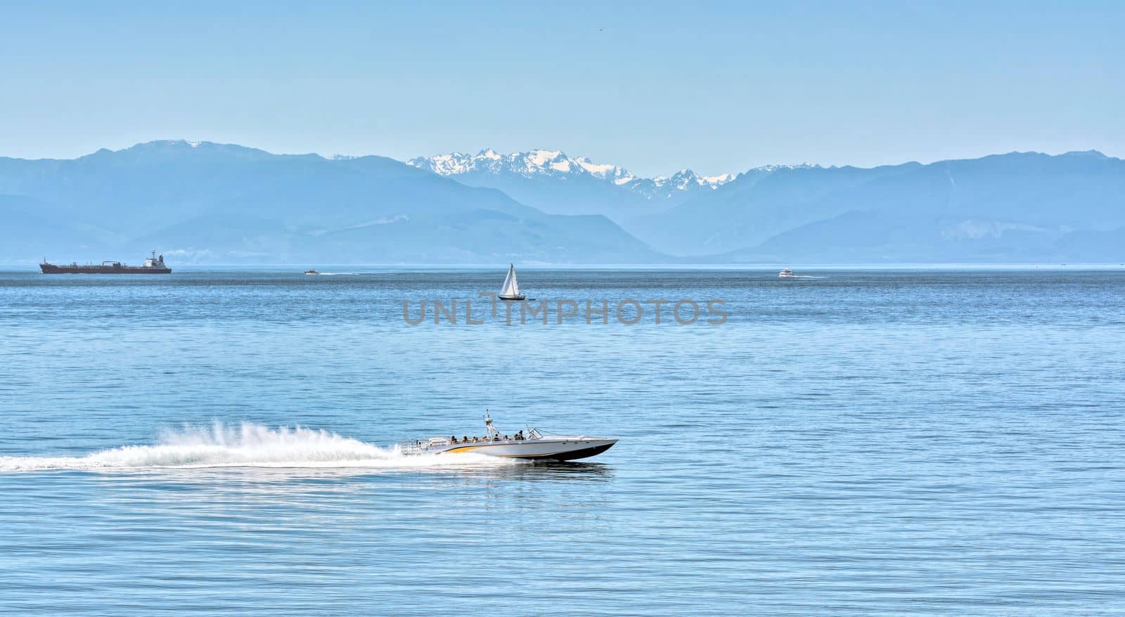 Power motor boat running over the bay with tourist tour on Vancouver island