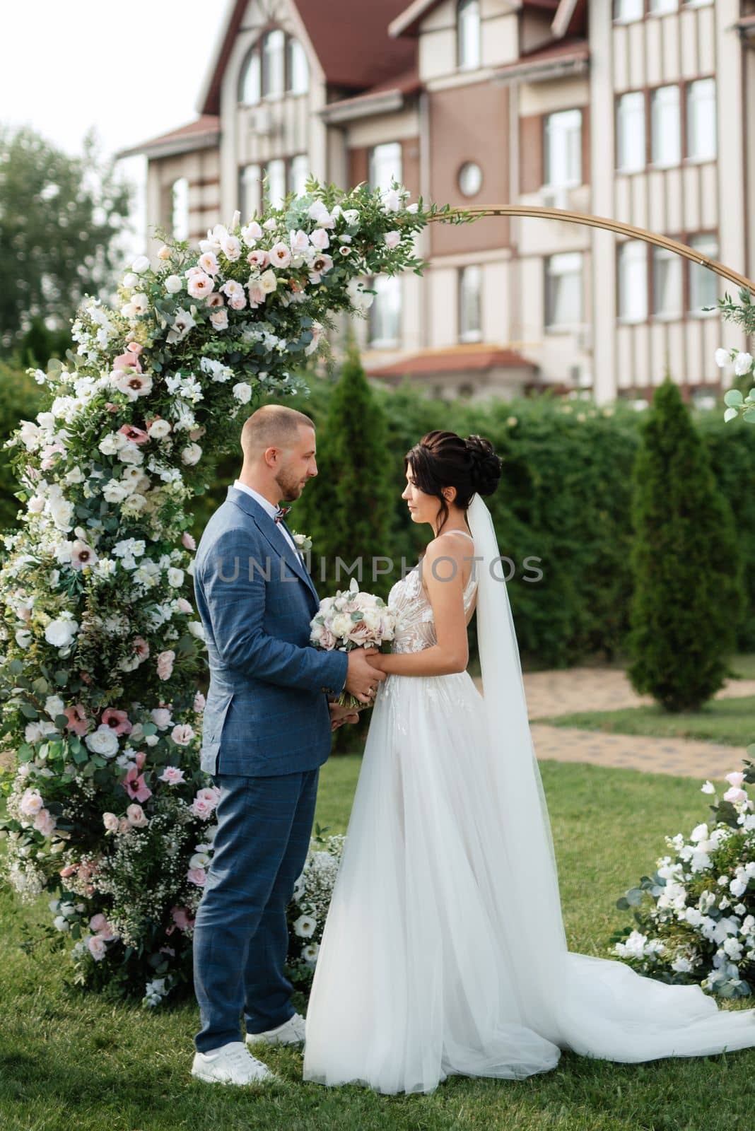 wedding ceremony of the newlyweds on the glade near the restaurant