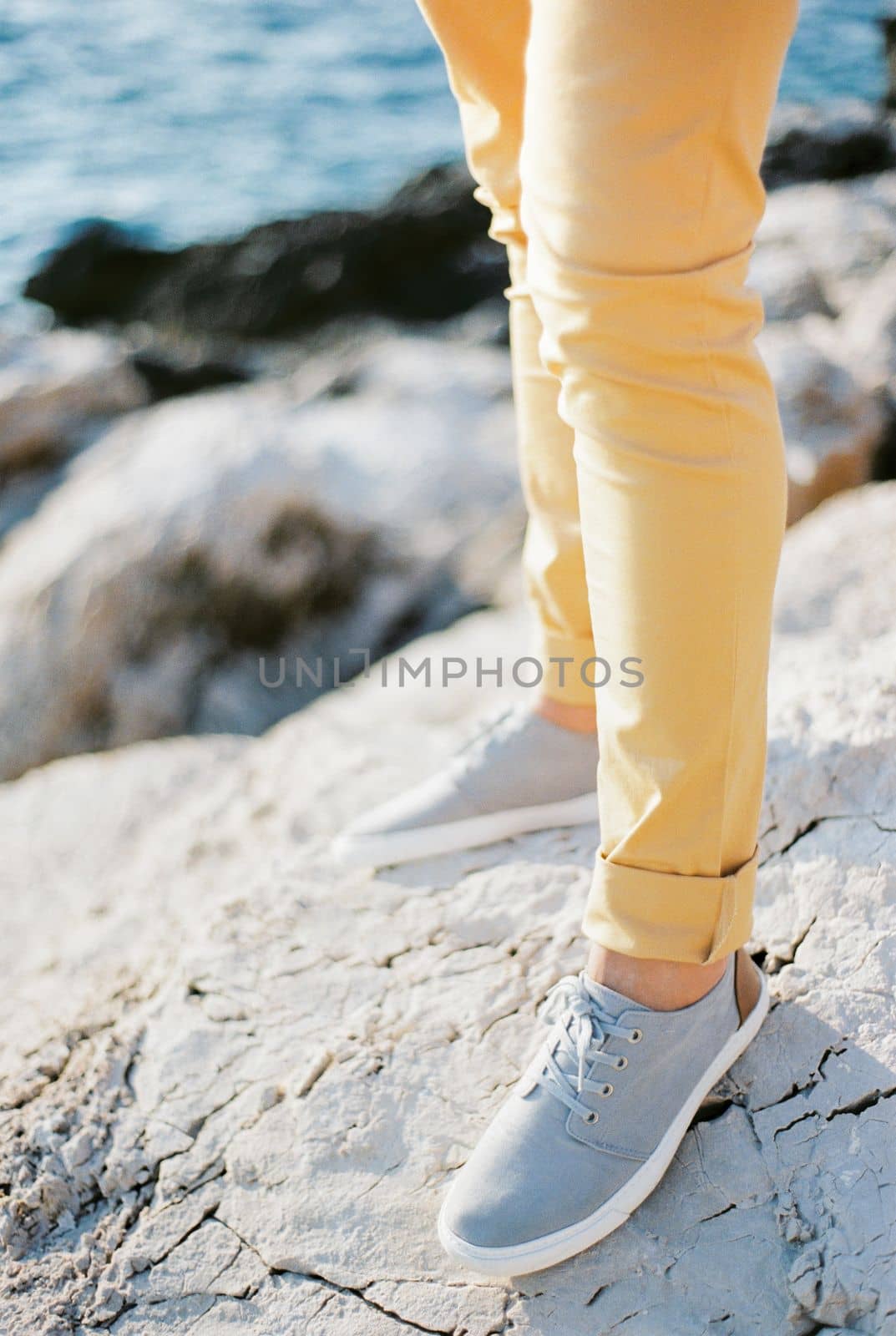 Men legs in trousers and sneakers. Close-up. High quality photo