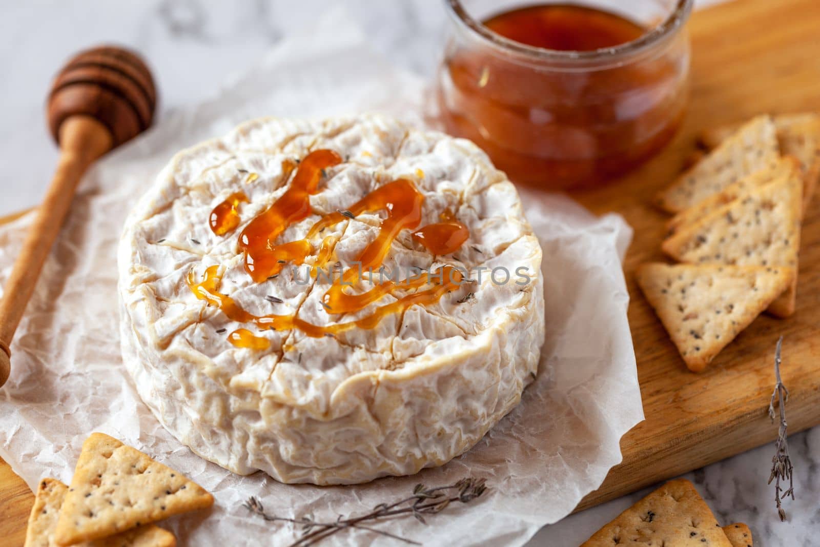 Camembert soft french cheese served with honey and crackers, top view by lanych