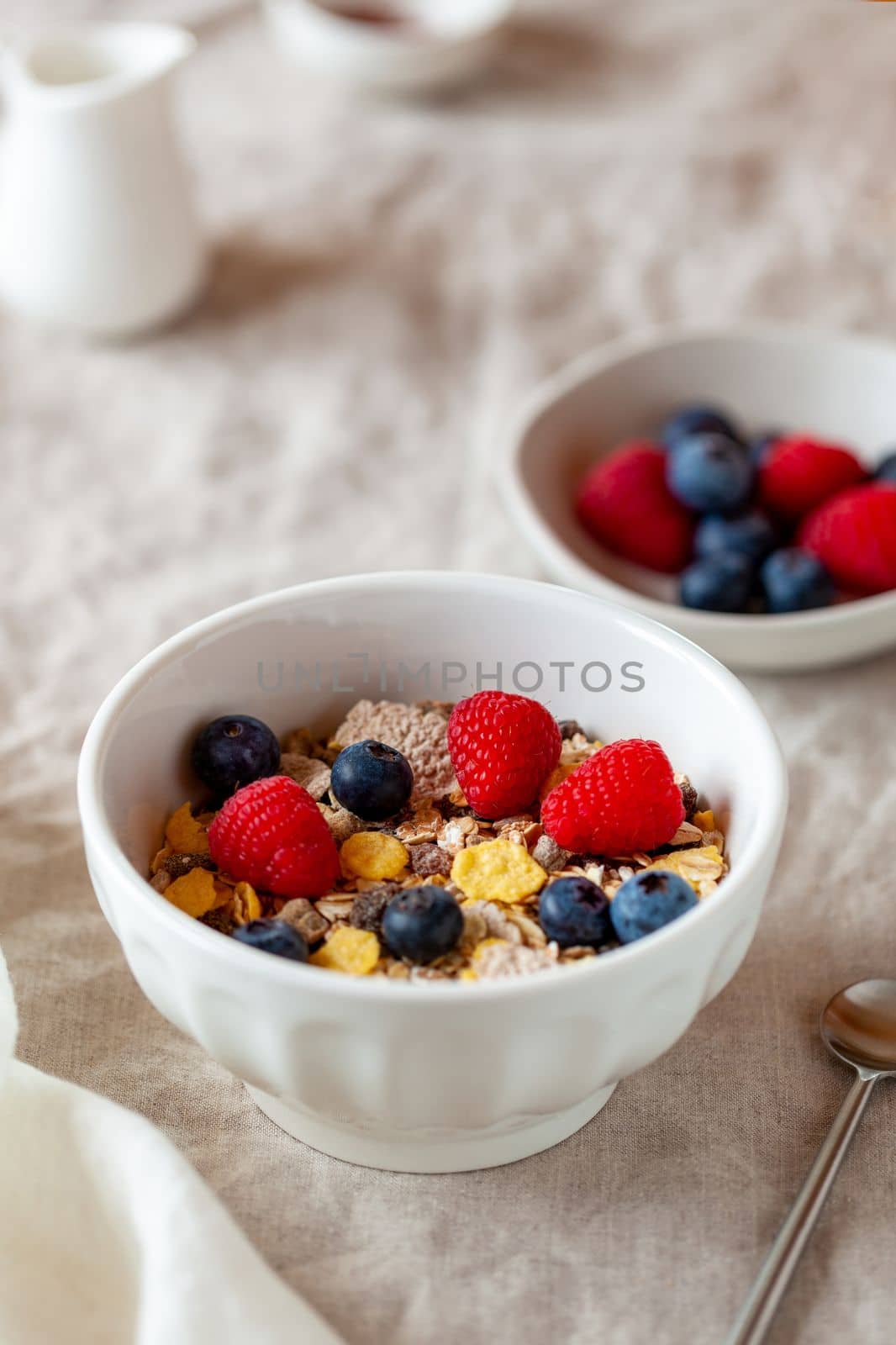 Oat flakes breakfast portion with raspberries, blueberries and honey by lanych