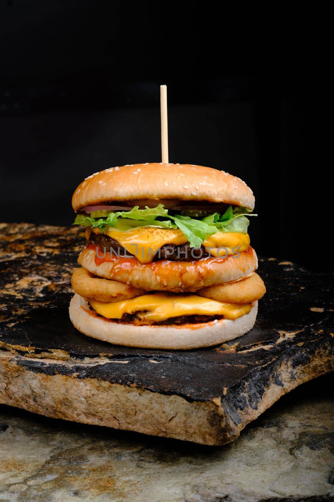 Rustic tasty Burger on Stone Background dark