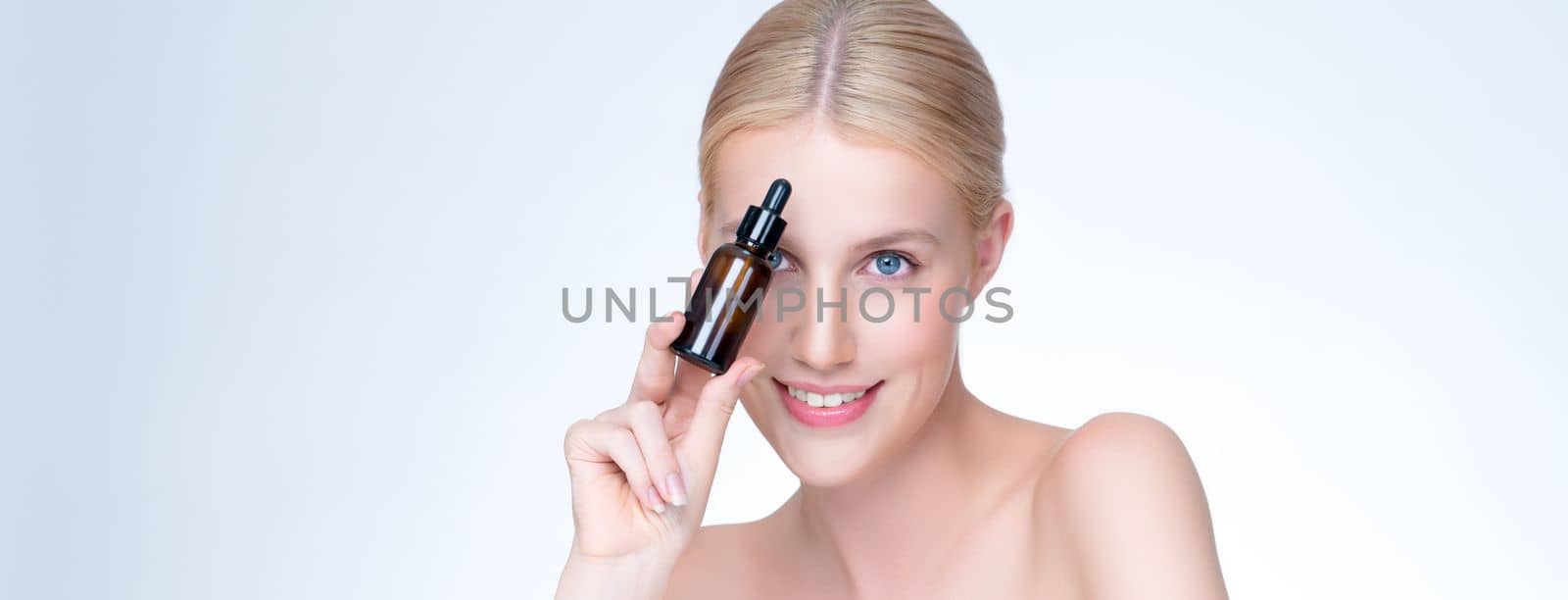 Personable portrait of beautiful woman applying essential oil bottle for skincare product. CBD oil dropper pipette for treatment and extracted cannabis concept in isolated background.