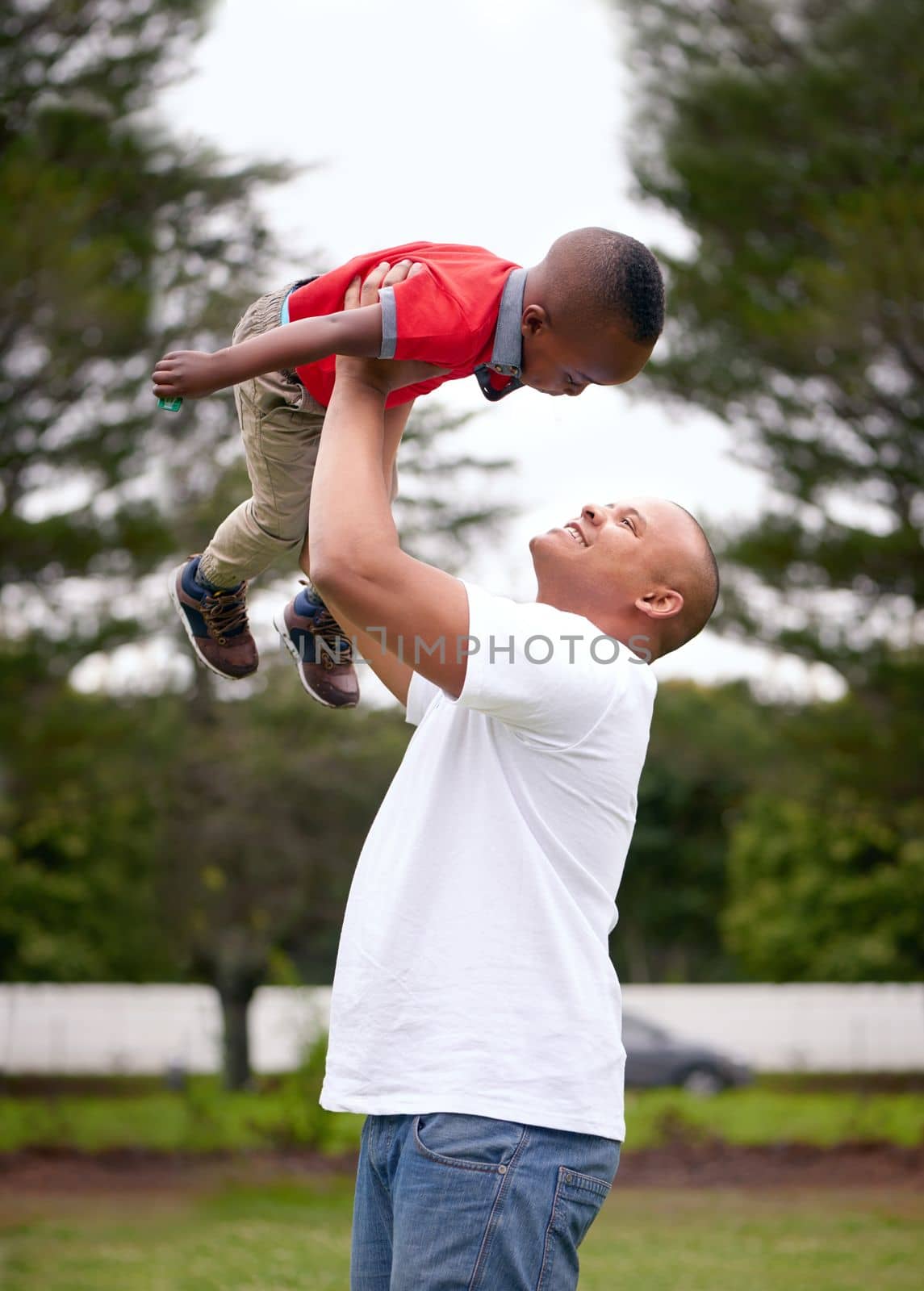 Every minute with him is priceless. a man spending time with his son outdoors