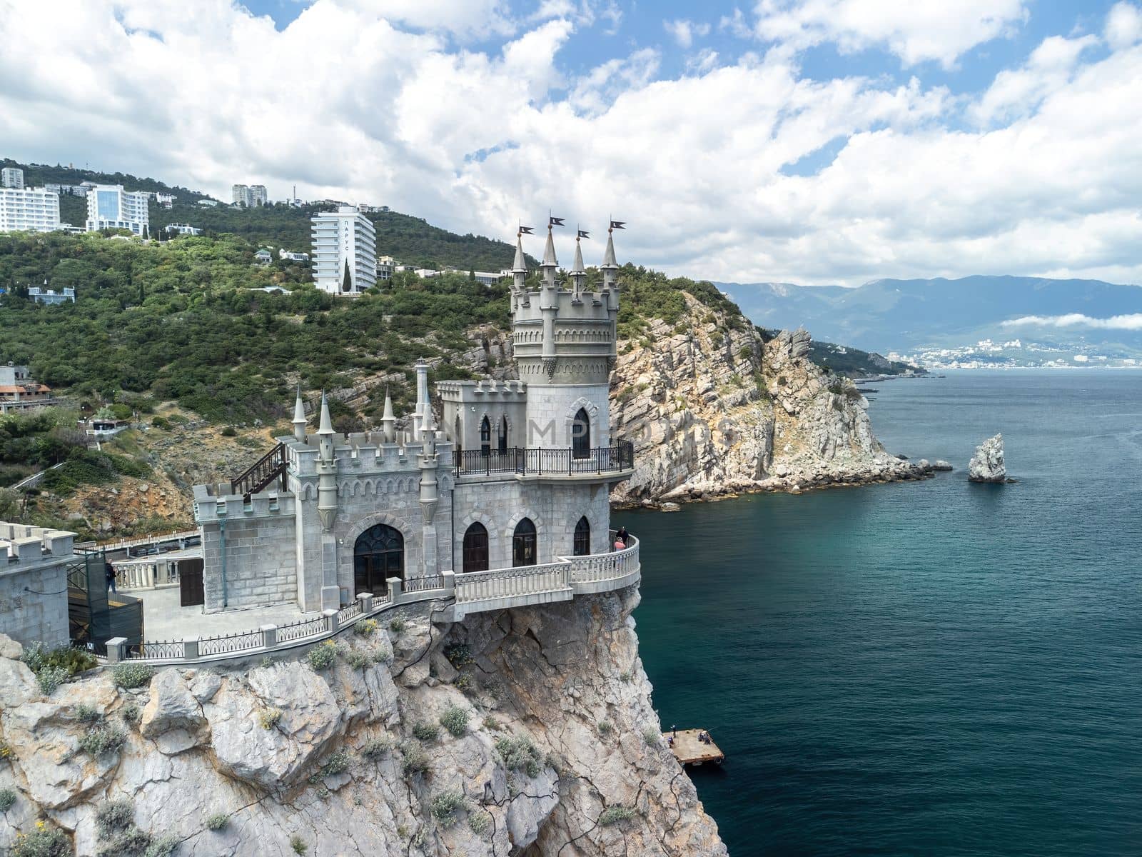 Crimea Swallow's Nest Castle on the rock over the Black Sea. It is a tourist attraction of Crimea. Amazing aerial view of the Crimea coast with the castle above abyss on sunny day. by panophotograph