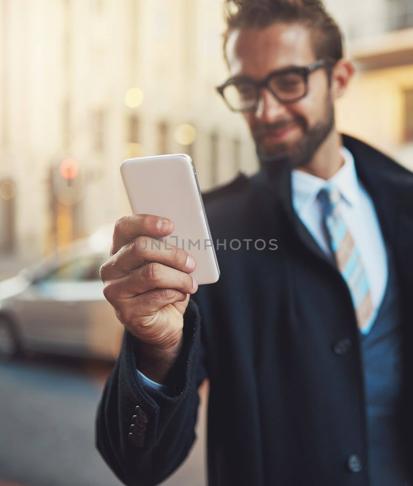 Wireless technology meets his modern needs. a stylish man using his phone in the city