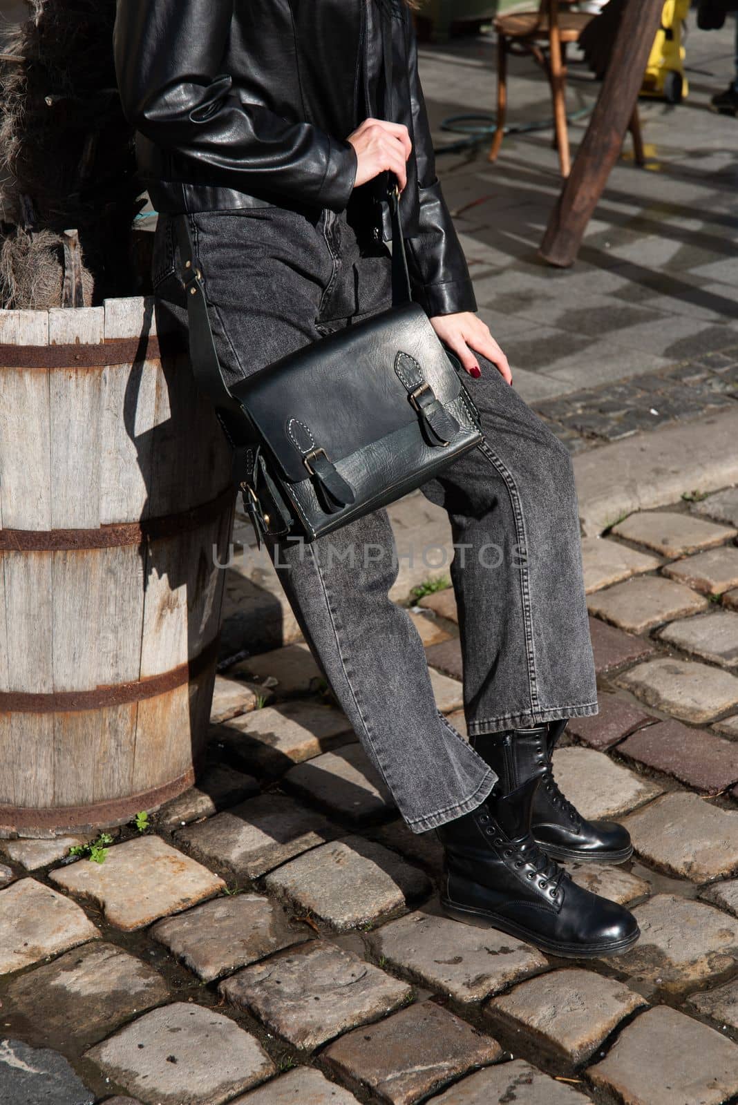 close-up photo of black leather bag corporate. a photo of a briefcase near an old wooden barrel by Ashtray25