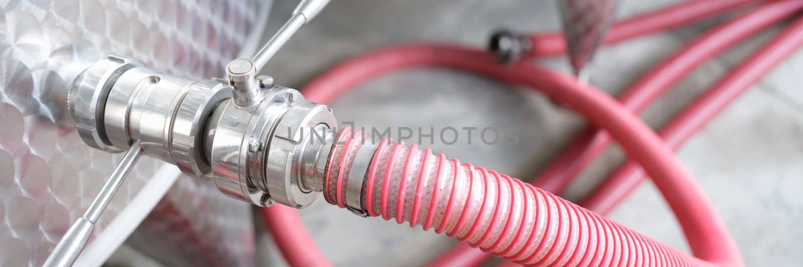 Stainless steel piping system with ball valves and hose. Production of alcoholic products of wine or chemical pharmaceuticals