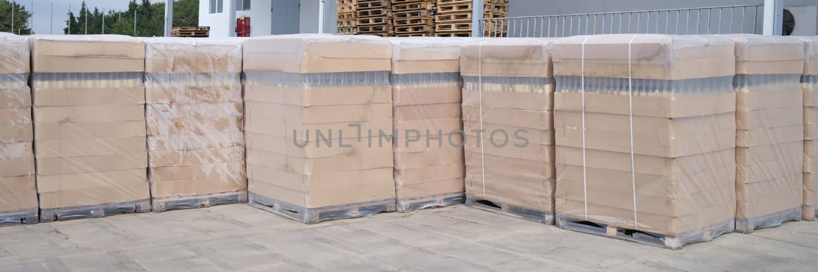 Rows of boxes and pallets in a warehouse and production warehouse. Warehouse storage of finished products concept