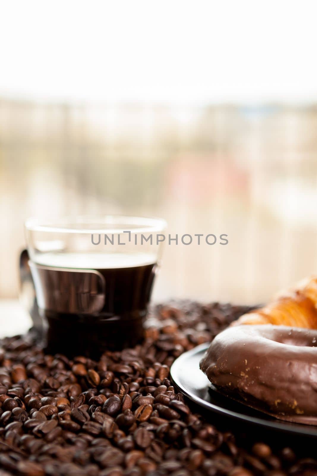 Croissant and coffee beans in close up by DCStudio