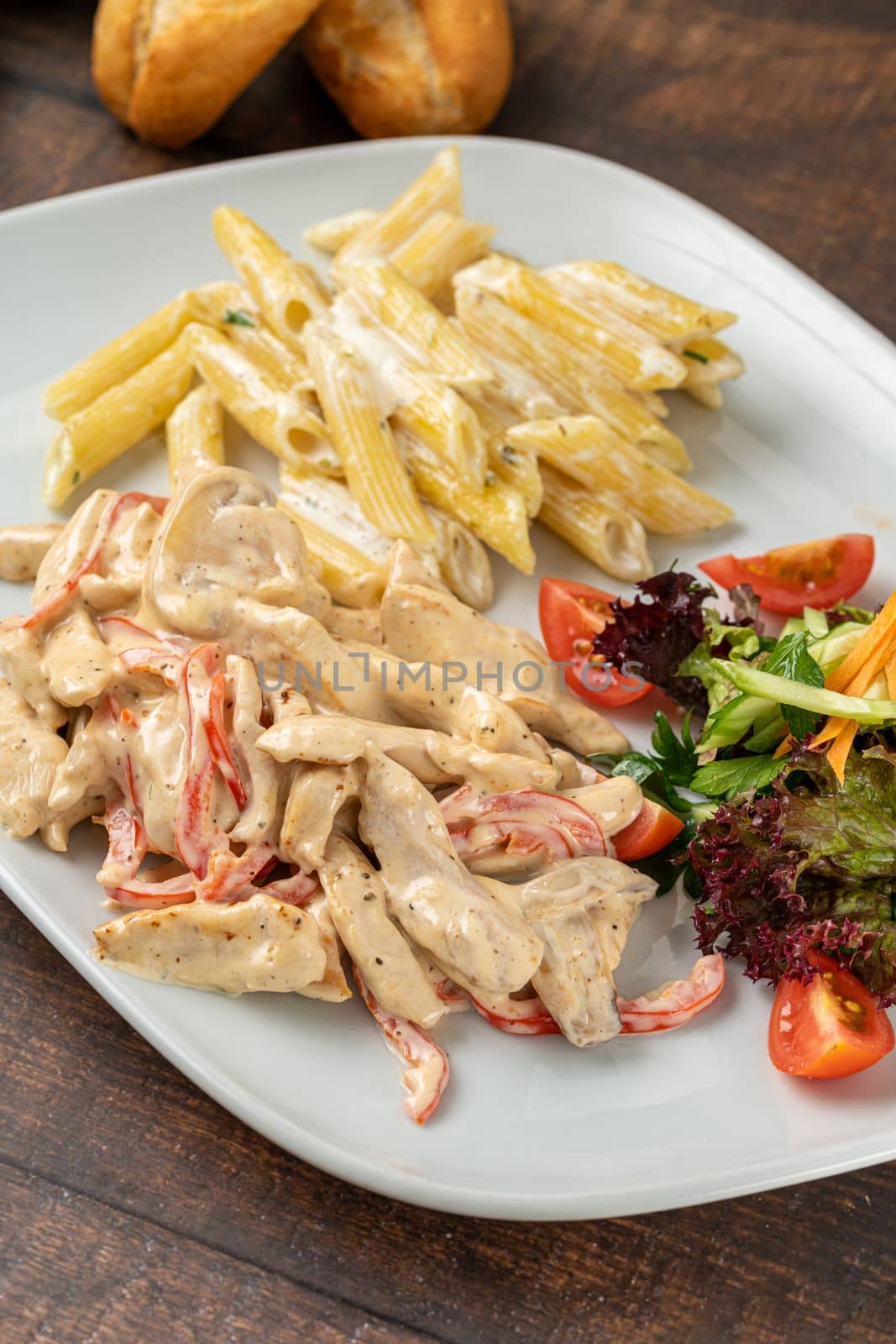 Grilled julienne cut chicken with pasta and salad