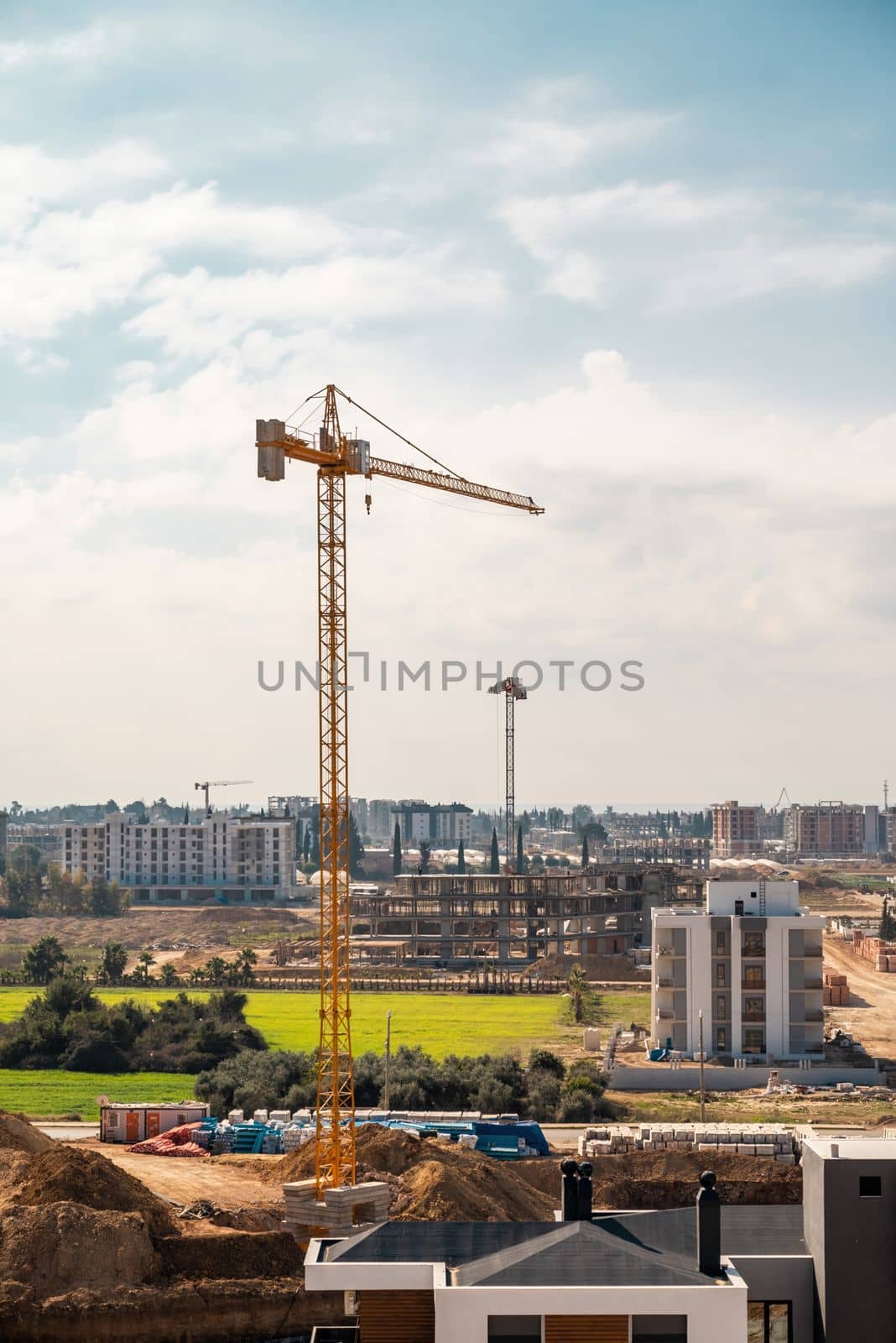 Construction crane working on large construction site