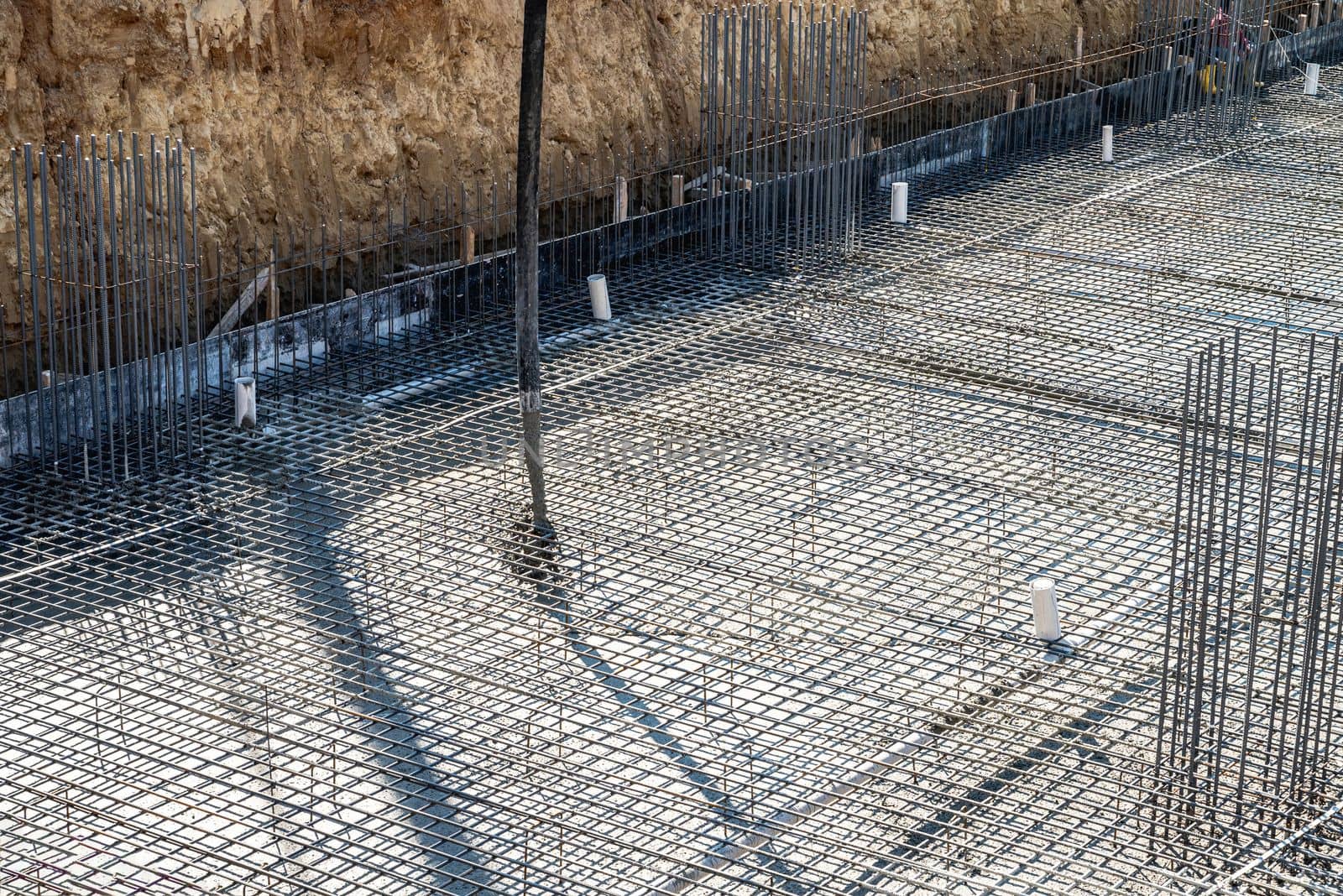 Concrete pump working on reinforced foundations at a large construction site